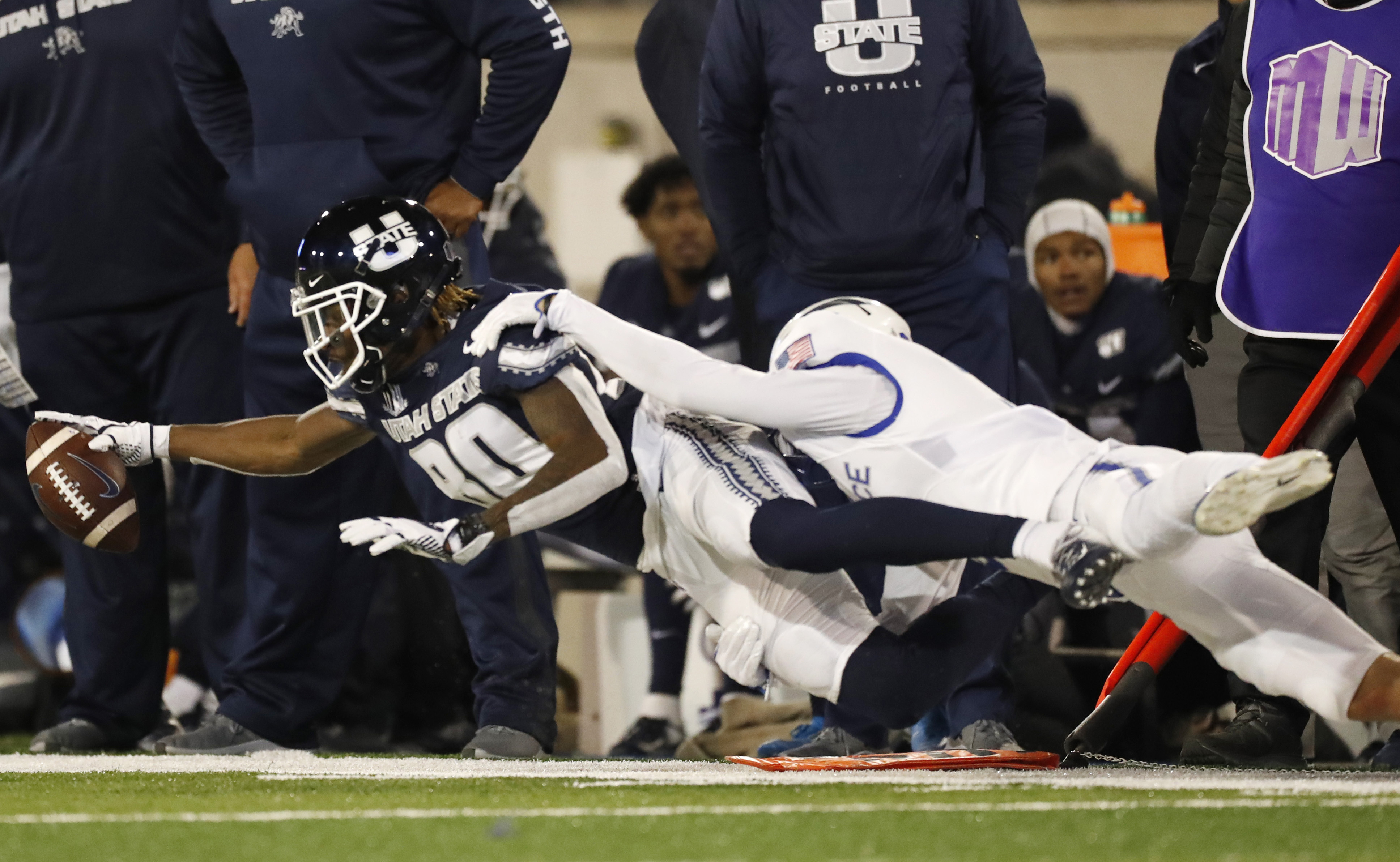 Utah State wide receiver Siaosi Mariner, left, is pulled down after catching a pass by Air Force defensive back Milton Bugg III in the second half of an NCAA college football game Saturday, Oct. 26, 2019, at Air Force Academy, Colo. Air Force won 31-7. (Photo: David Zalubowski, AP)