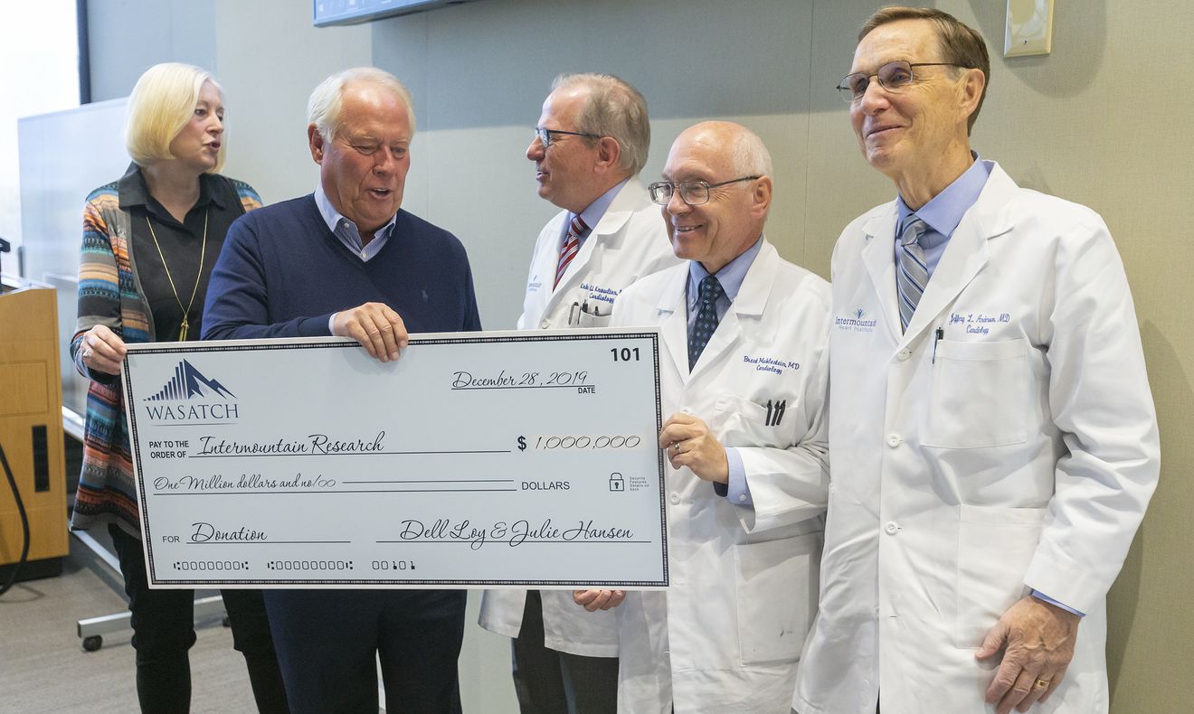 Michele Teran, left, discusses a study that aims to better identify and treat people at risk of having a heart attack before they develop problems as businessman and Real Salt Lake owner Dell Loy Hansen, second from left, and Dr. Kirk Knowlton, director of cardiovascular research at the Intermountain Heart Institute, look on during a press conference at Intermountain Healthcare in Murray on Monday, Oct. 28, 2019. (Photo: Scott G Winterton, KSL)