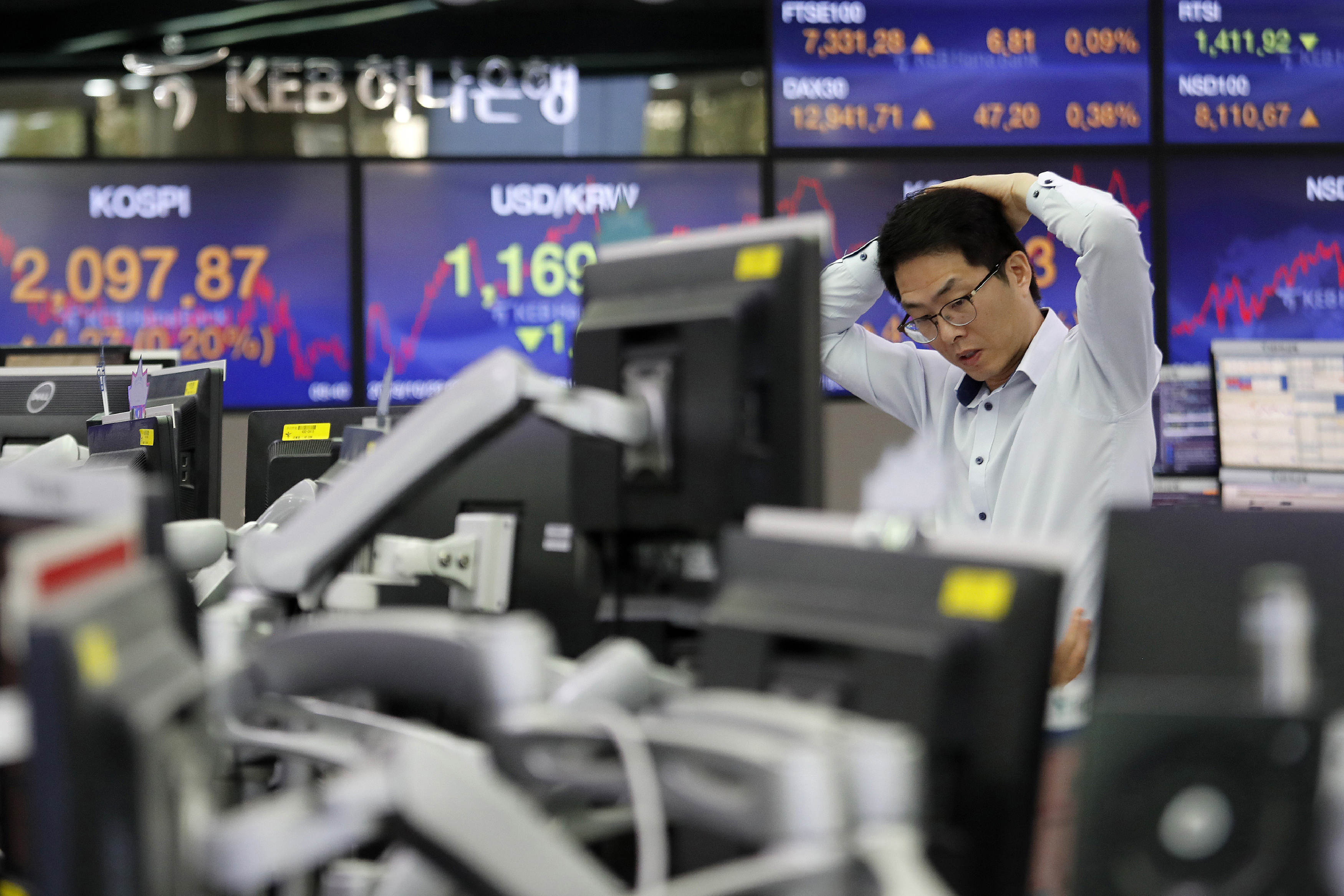 Global markets dip as week of earnings, reports heats up