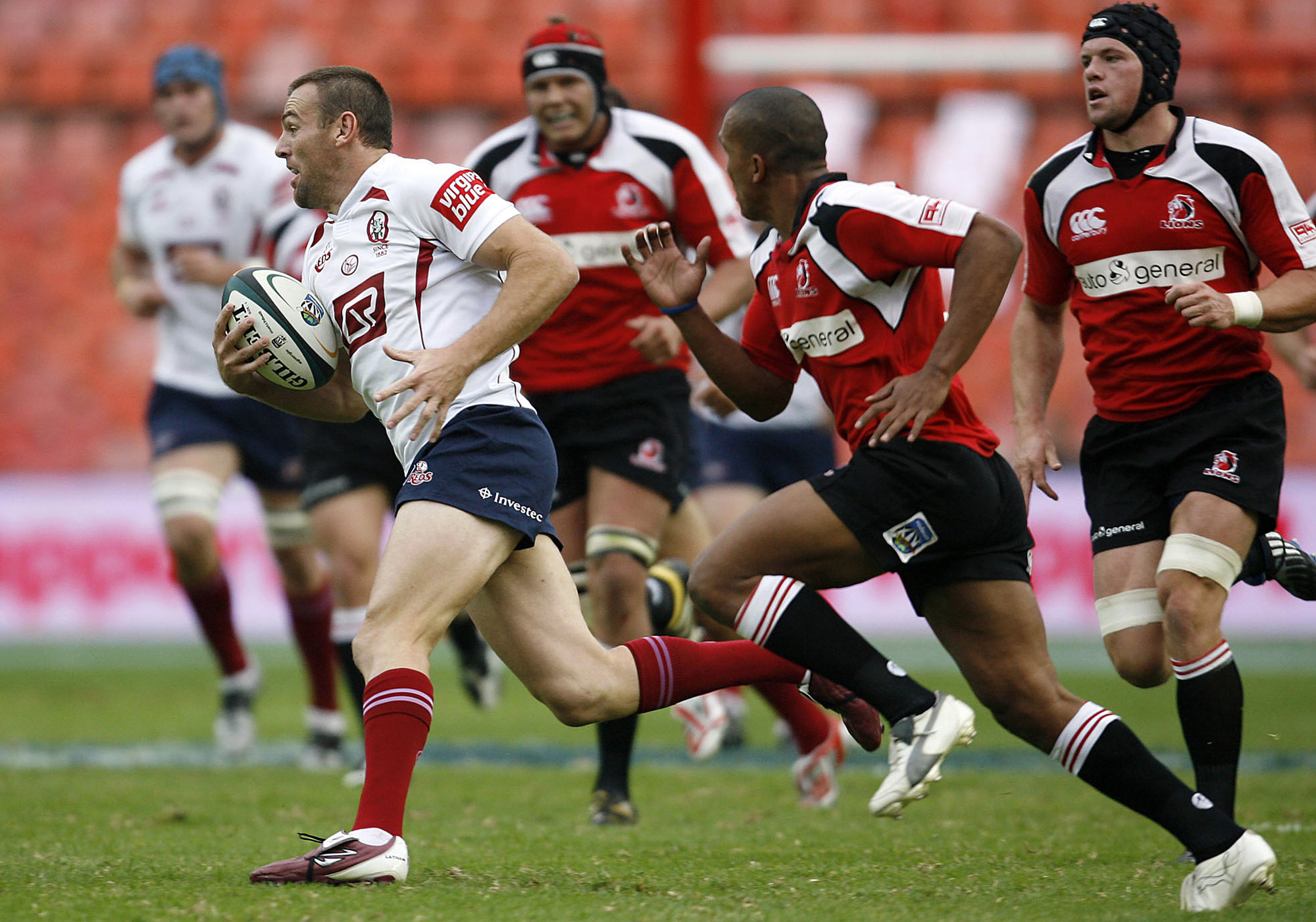 Australia's Reds Chris Latham, left, attacks as South Africa's Lions Dusty Noble, second from right, vies for the ball during their Super14 rugby match at the Ellis Park stadium in Johannesburg, South Africa, Saturday, March 22, 2008. The match ended in a 24-all draw. (AP Photo)