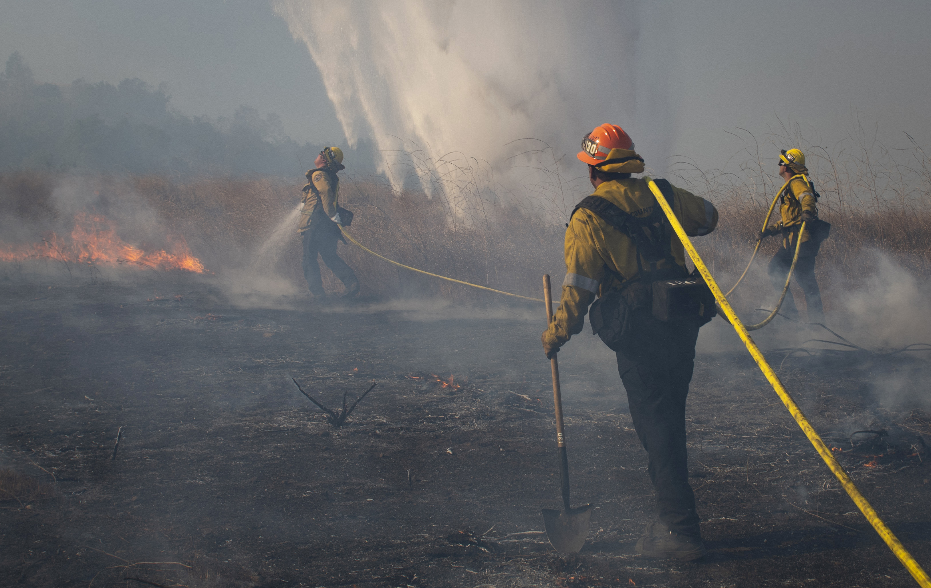 The Latest: Firefighters slow growth of blaze near LA