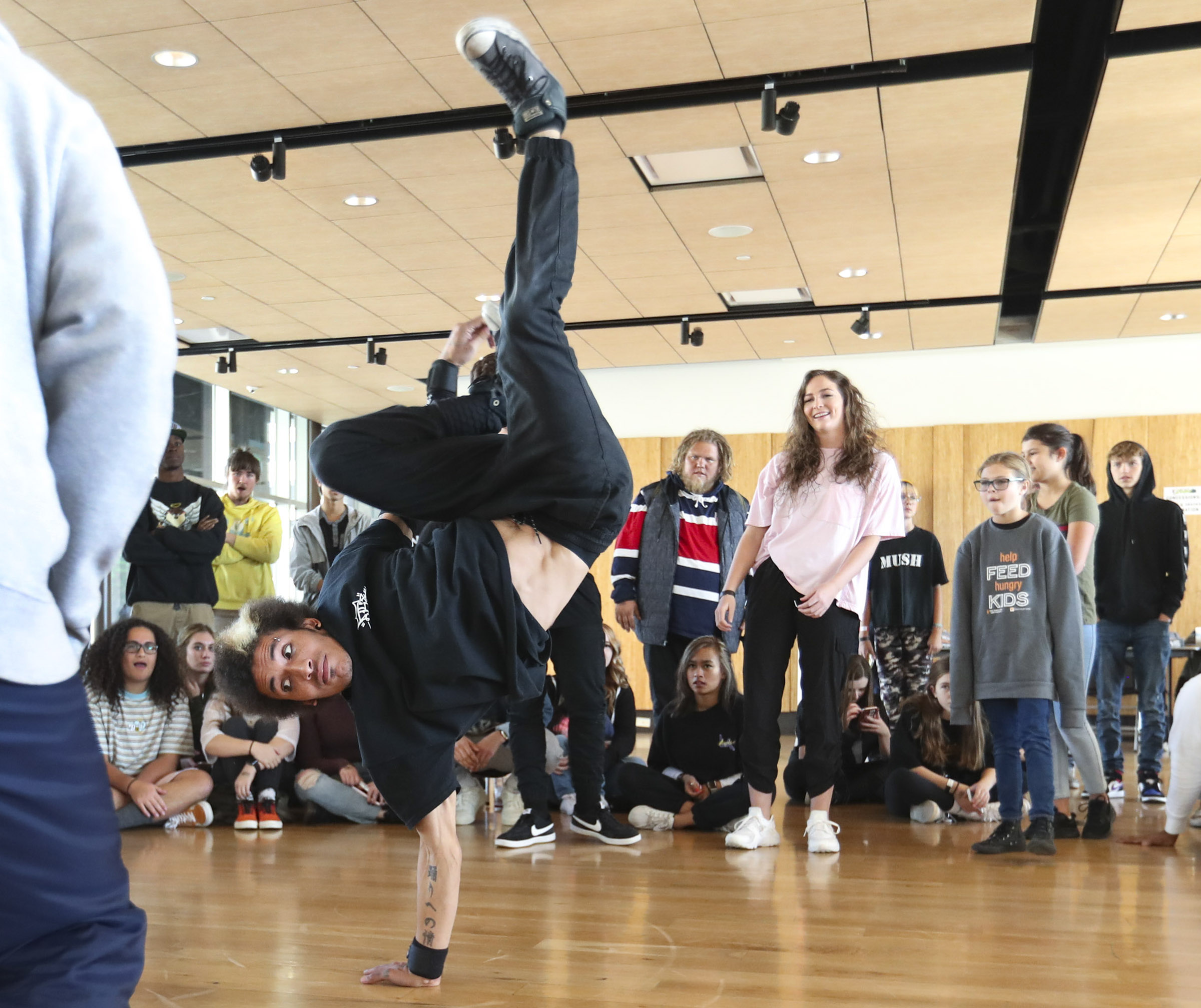 Bryan Bower does a hand stand as he competes with his partner Tonga Lavulo in the senior hip-hop division at the Peanut Butter Jamm at the Gallivan Center in Salt Lake City on Saturday, Nov. 2, 2019. Hundreds of dancers of all ages competed in junior and senior divisions to fight childhood hunger in Utah. Entry to the event was a jar of peanut butter to help feed hungry kids. (Steve Griffin, KSL)