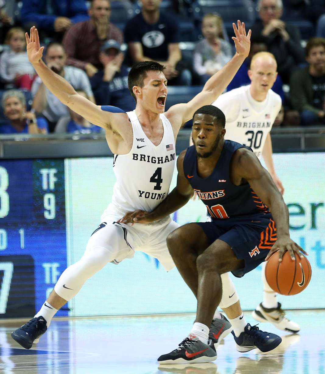 BYU Cougars guard Alex Barcello (4) defends Cal State Fullerton Titans guard Austen Awosika (10) as BYU and Cal State Fullerton play a college basketball game at the Marriott Center in Provo on Tuesday, Nov. 5, 2019. (Photo: Scott G Winterton, KSL)