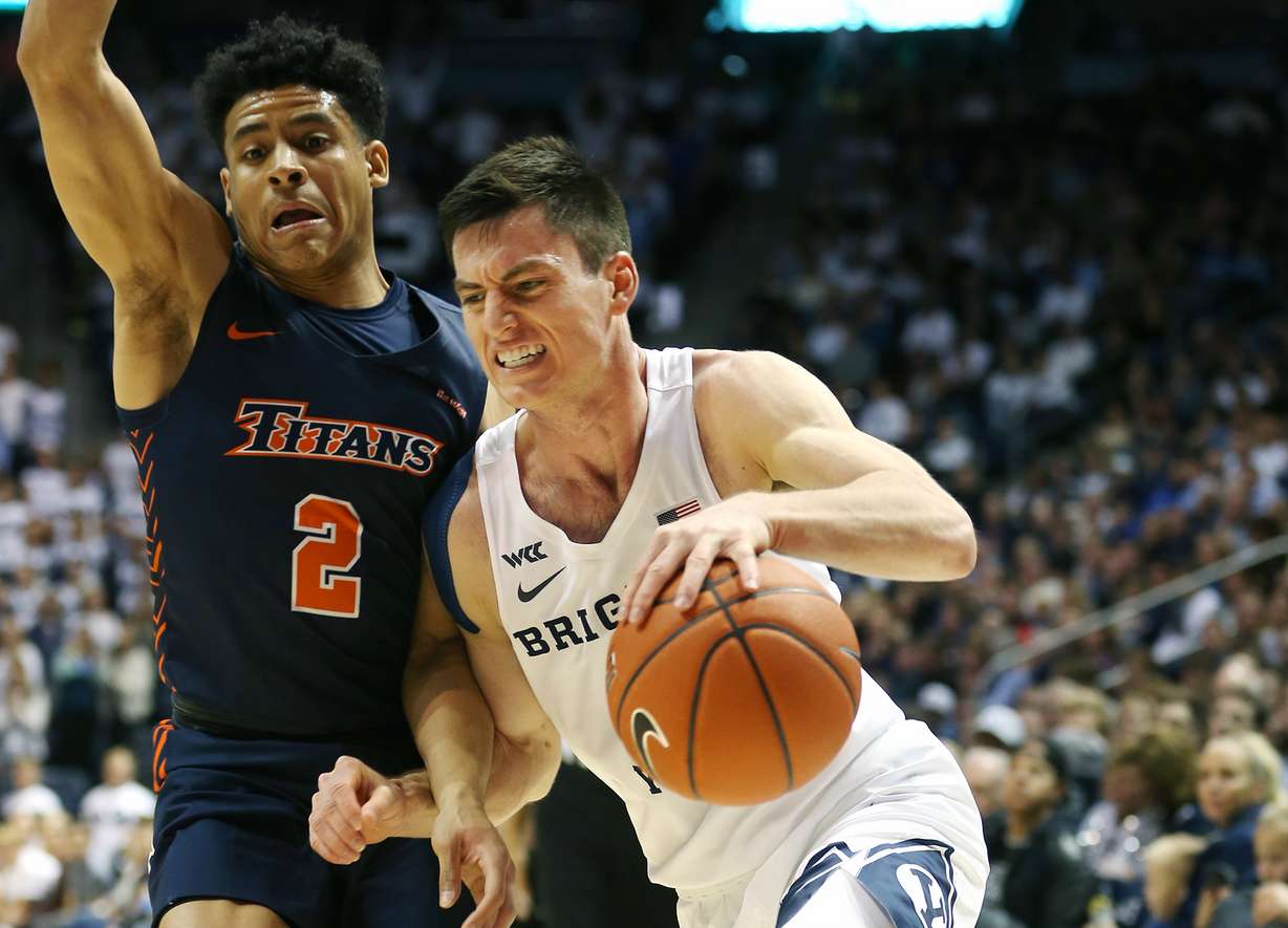 Cal State Fullerton Titans guard Daniel Venzant (2) defends Brigham Young Cougars guard Alex Barcello (4) as BYU and Cal State Fullerton play a college basketball game at the Marriott Center in Provo Utah on Tuesday, Nov. 5, 2019. BYU won 76-58. (Photo: Scott G Winterton, KSL)
