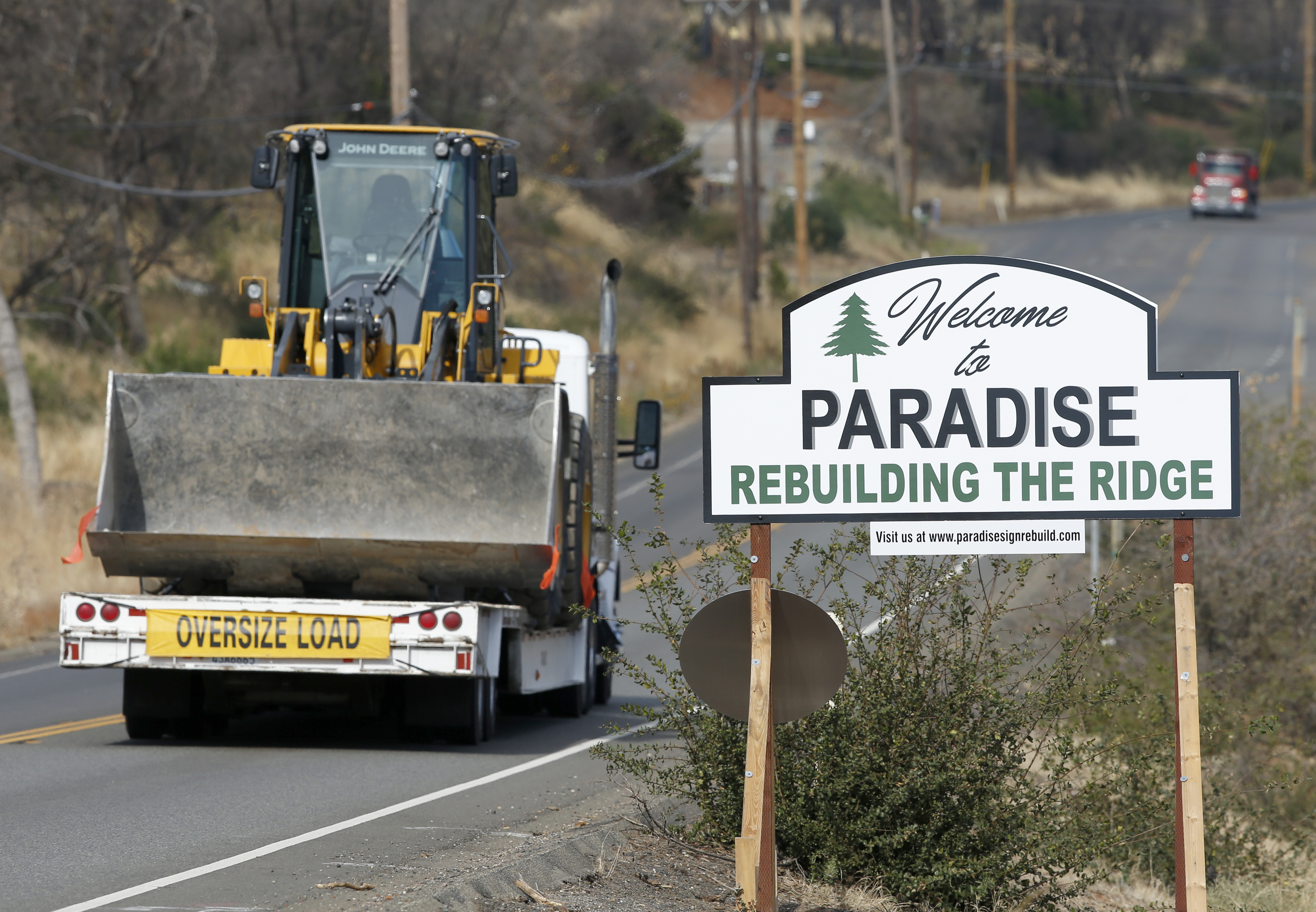 Vehicles pass a sign welcoming people to Paradise, Calif., Tuesday Nov. 5, 2019. The sign also displays the slogan, 'Rebuilding The Ridge,' that has become the community's rallying cry since a wildfire devastated the area a year earlier. Photo: Rich Pedroncelli, AP Photo
