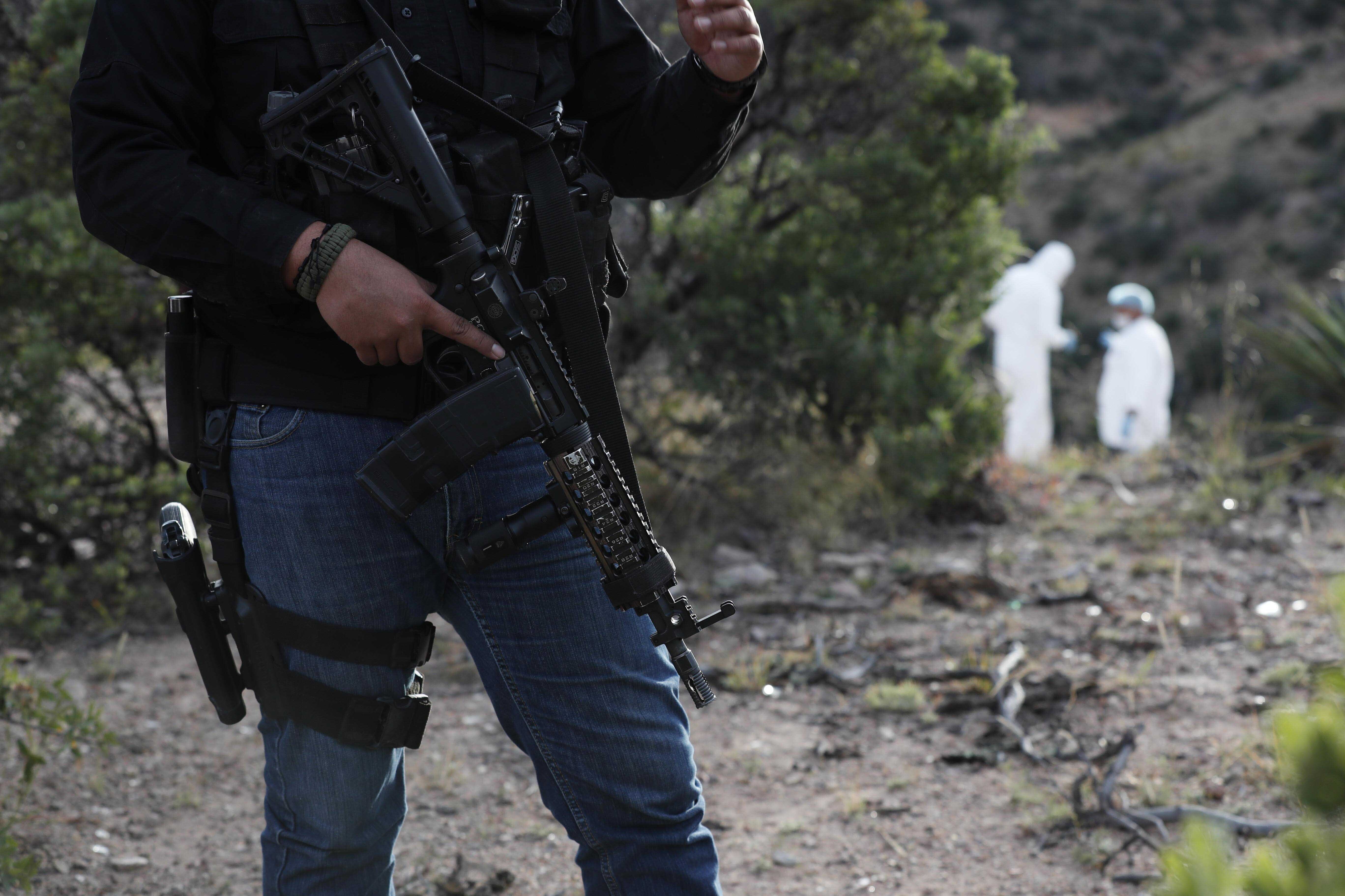 Under heavy security forensic investigators walk the site where nine U.S. citizens, three women and six children related to the extended LeBaron family, were slaughtered when cartel gunmen ambushed three SUVs along a dirt road near Bavispe. (Photo: Marco Ugarte, AP)