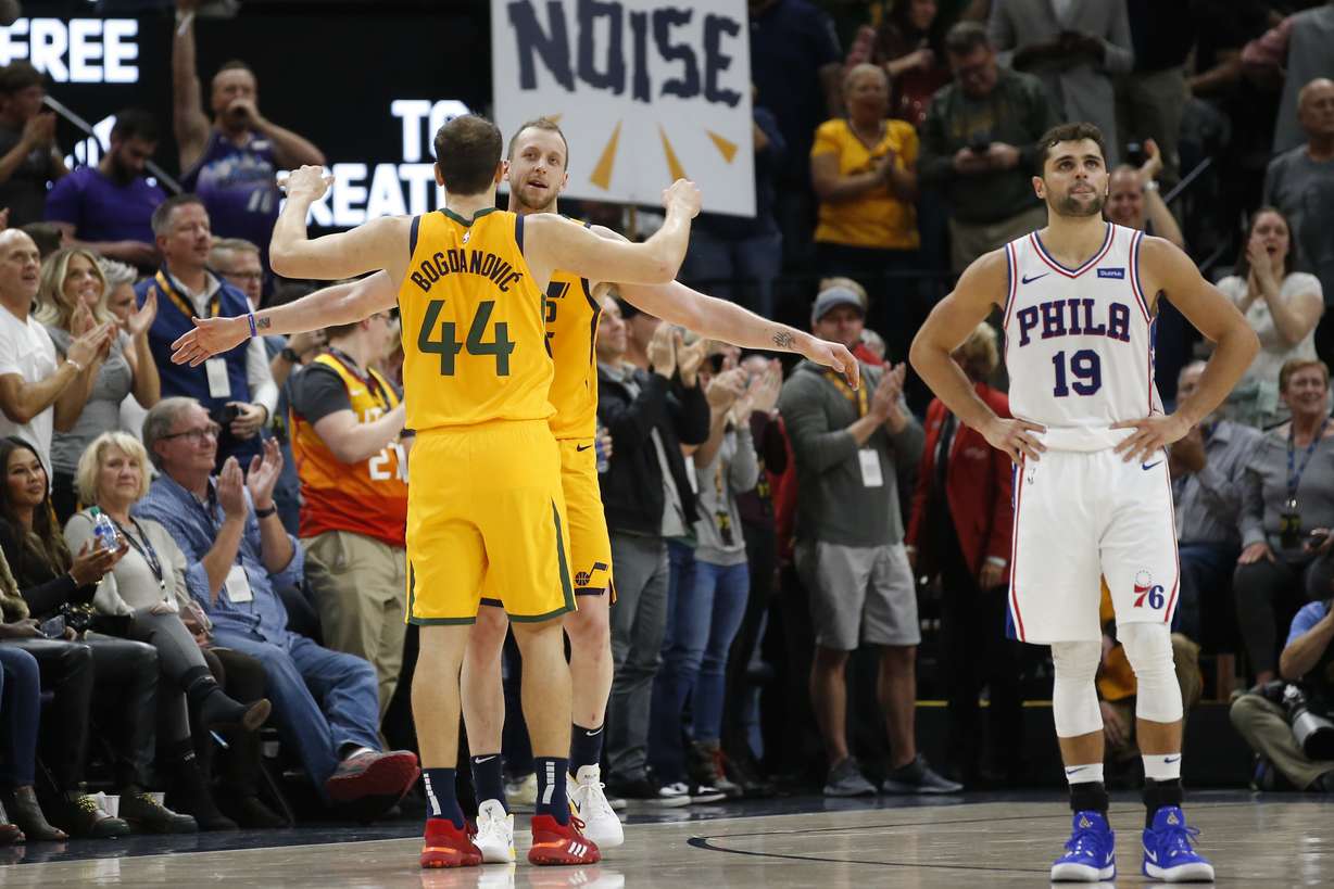 Utah Jazz's Joe Ingles, left rear, and Bojan Bogdanovic (44) celebrate as Philadelphia 76ers guard Raul Neto (19) looks at the clock late in the second half of an NBA basketball game Wednesday, Nov. 6, 2019, in Salt Lake City. (AP Photo/Rick Bowmer)
