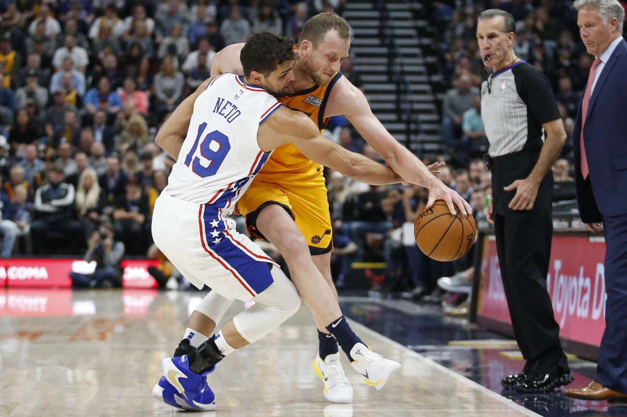 Philadelphia 76ers guard Raul Neto (19) fouls Utah Jazz forward Joe Ingles, right, as he drives up court in the first half during an NBA basketball game Wednesday, Nov. 6, 2019, in Salt Lake City. (AP Photo/Rick Bowmer)
