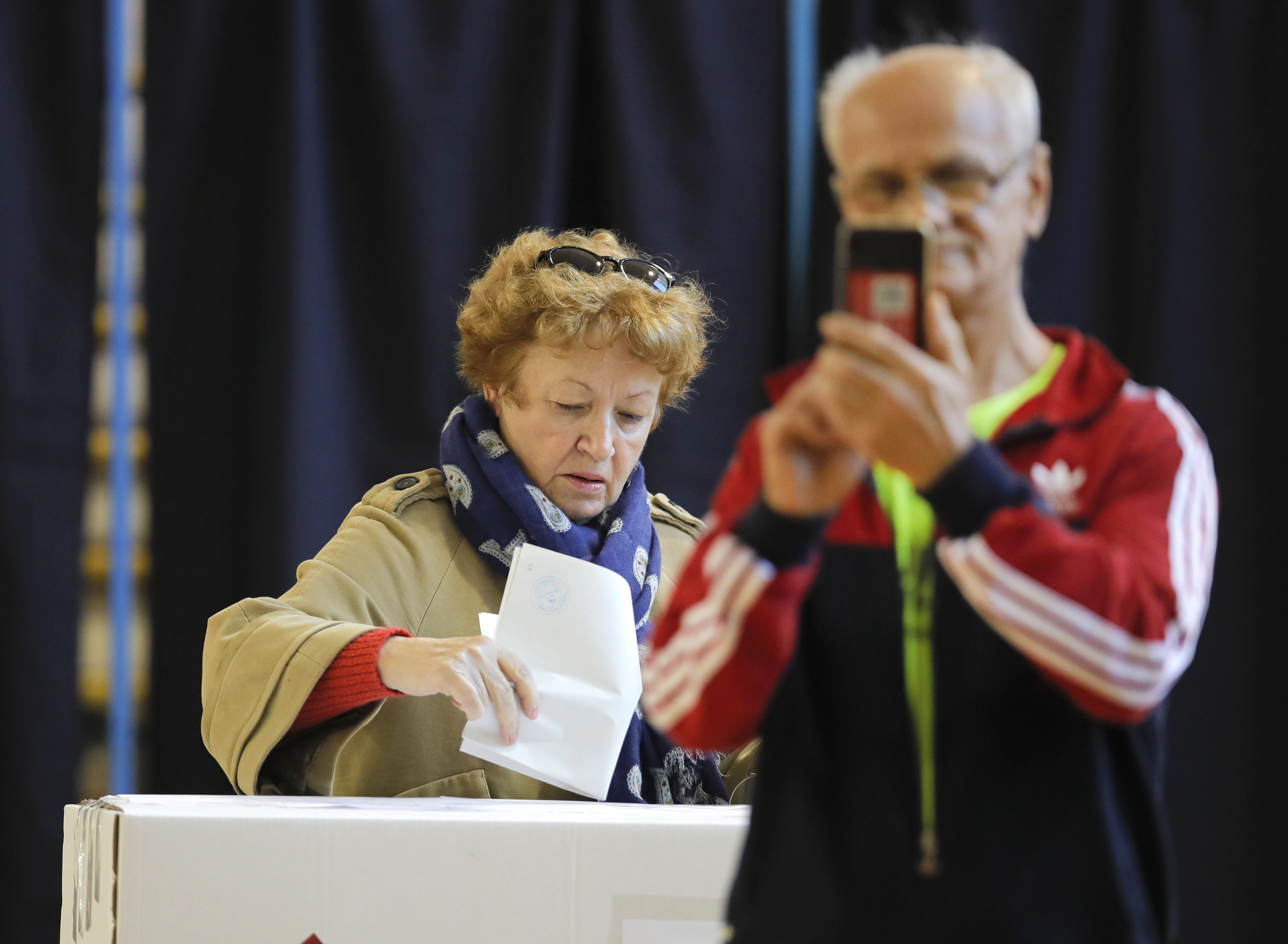 The Latest: Exit polls see runoff in Romania president vote
