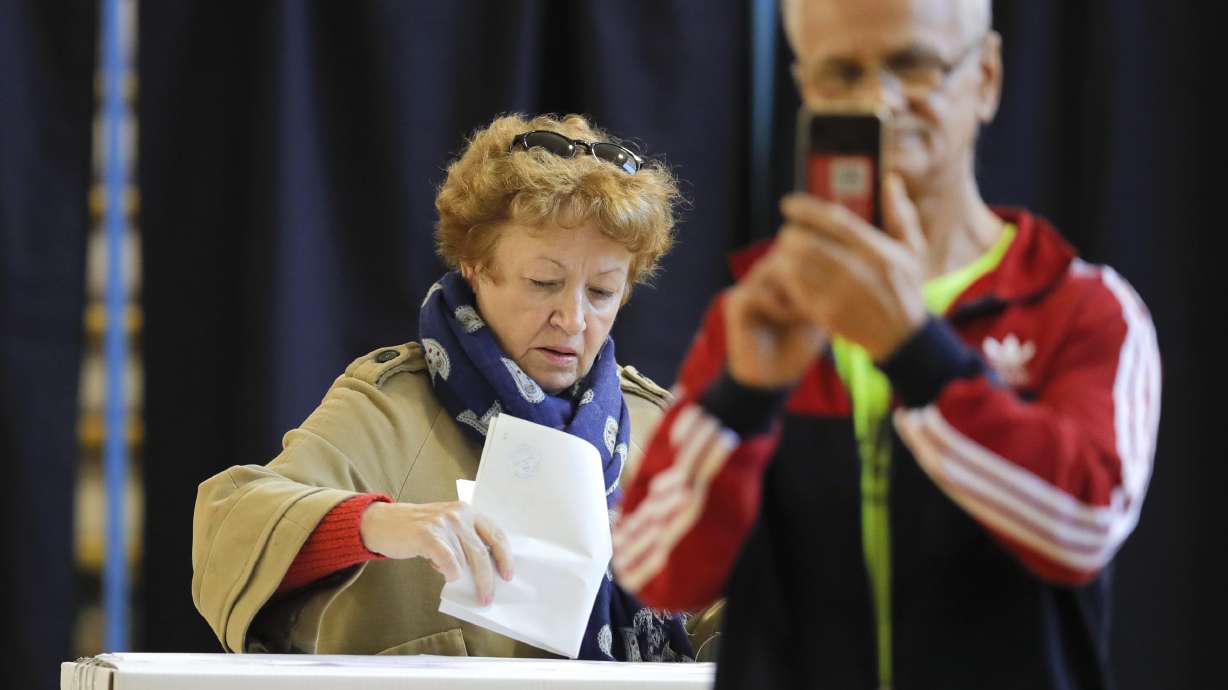 The Latest: Exit polls see runoff in Romania president vote