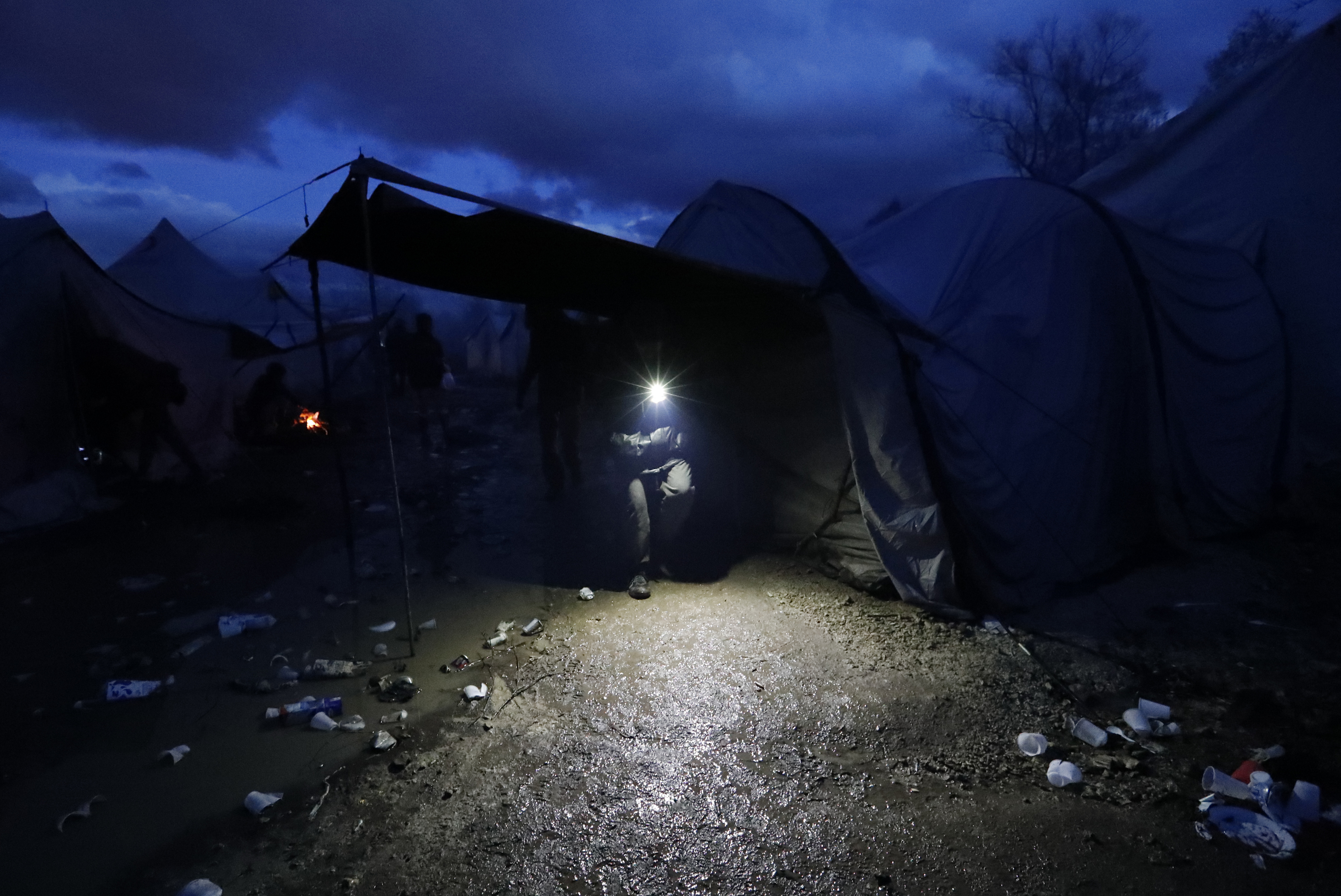 Migrants huddle in the cold in makeshift camp in Bosnia