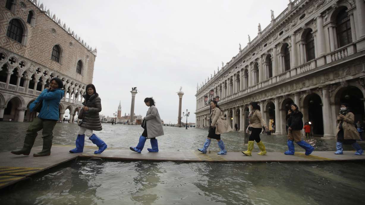 High tides surge through Venice, locals rush to protect art