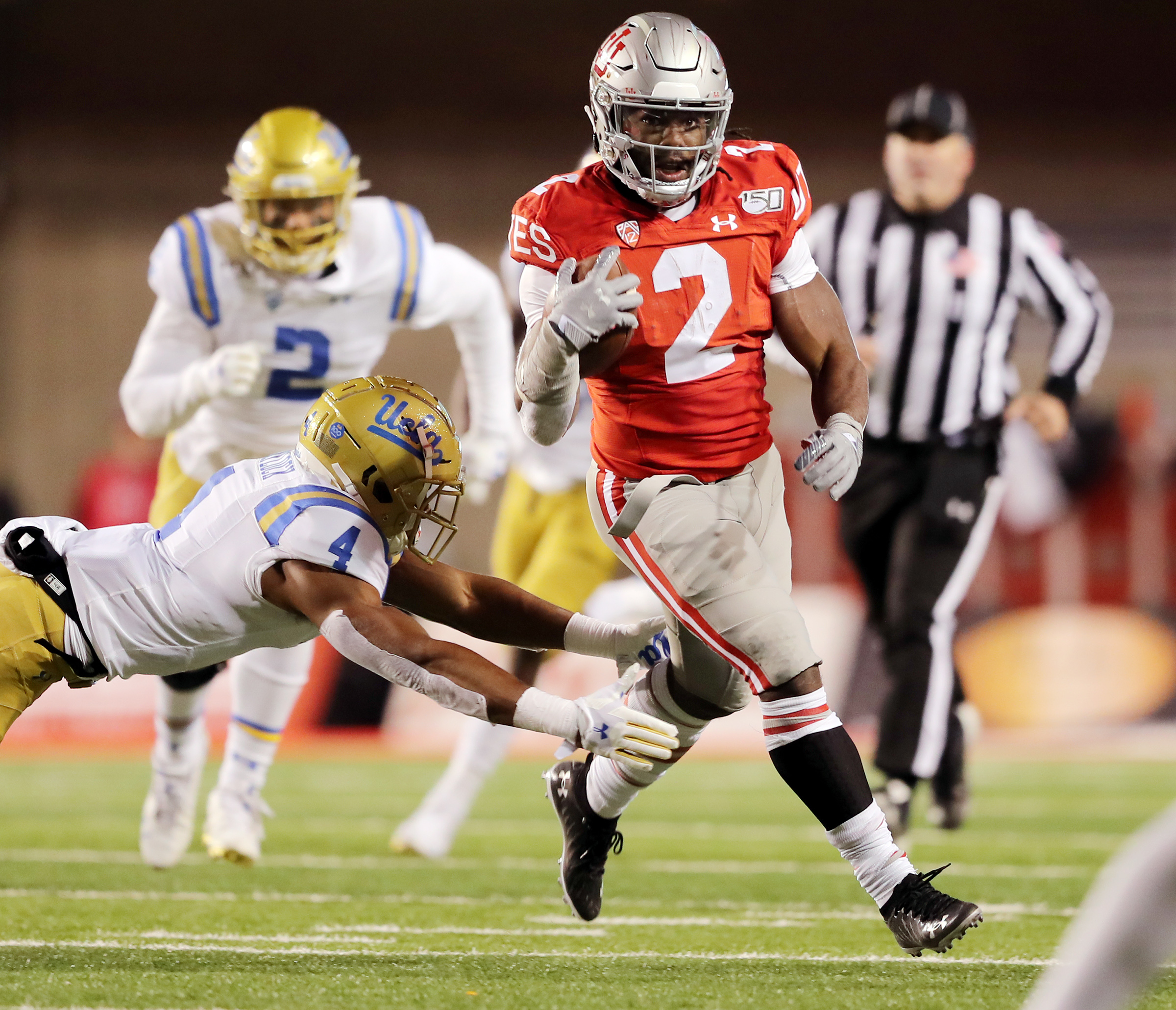 Utah Utes running back Zack Moss (2) breaks away from UCLA Bruins defensive back Stephan Blaylock (4) as Utah and UCLA play a college football game in Salt Lake City at Rice-Eccles Stadium on Saturday, Nov. 16, 2019. (Photo: Scott G Winterton, KSL)