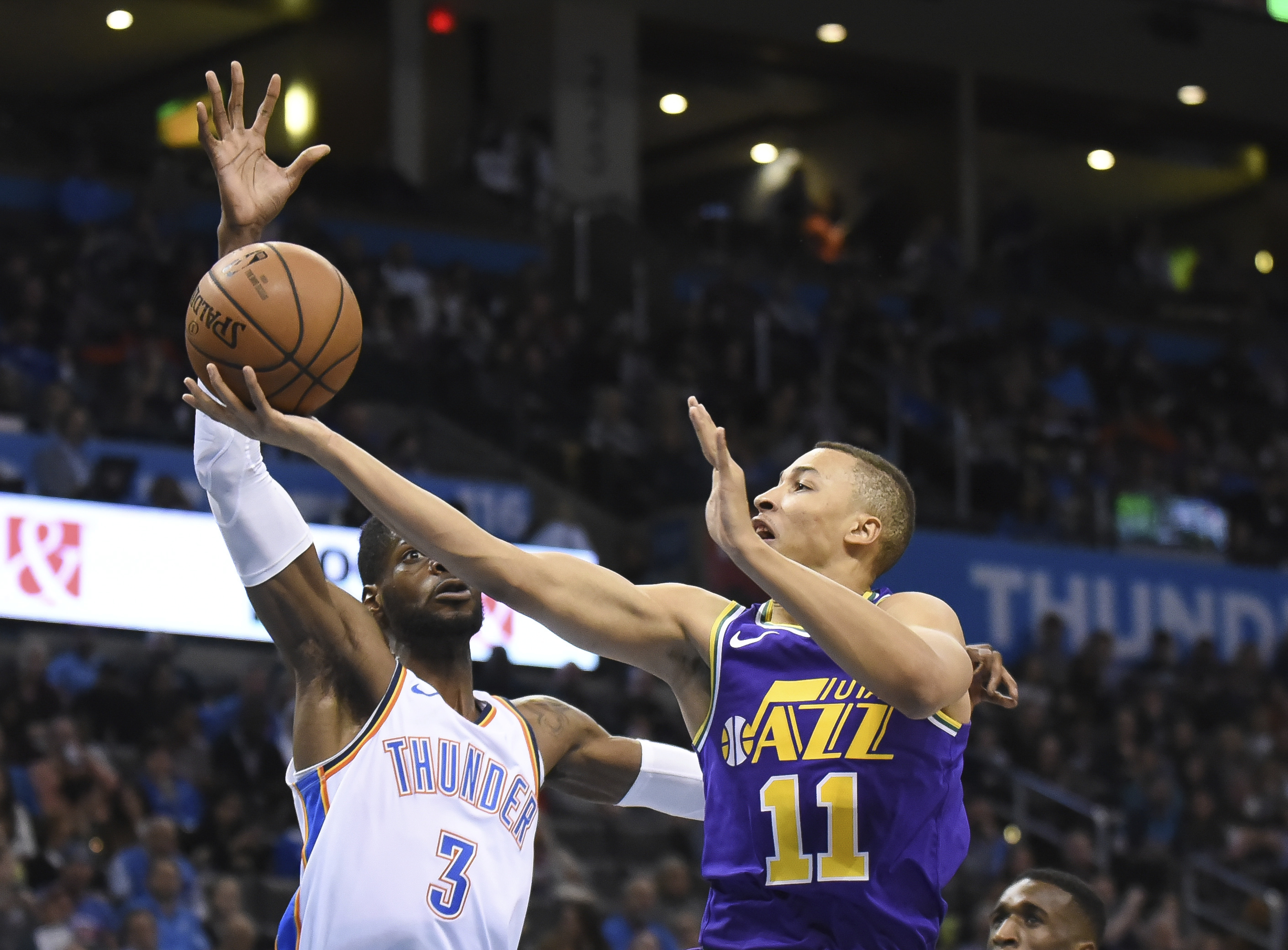 Utah Jazz guard Dante Exum (11) goes up for a shot over Oklahoma City Thunder forward Nerlens Noel (3) in the second half of an NBA basketball game in Oklahoma City, Monday, Dec. 10, 2018. (AP Photo/Kyle Phillips)