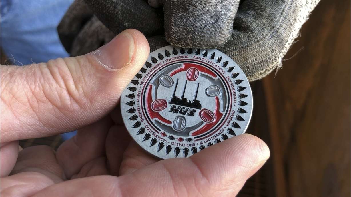 In this Aug. 21, 2019, image, a Navajo Generating Station employee holds a challenge coin that was given to workers at the plant near Page, Ariz.. Photo: Susan Montoya Bryan, AP Photo