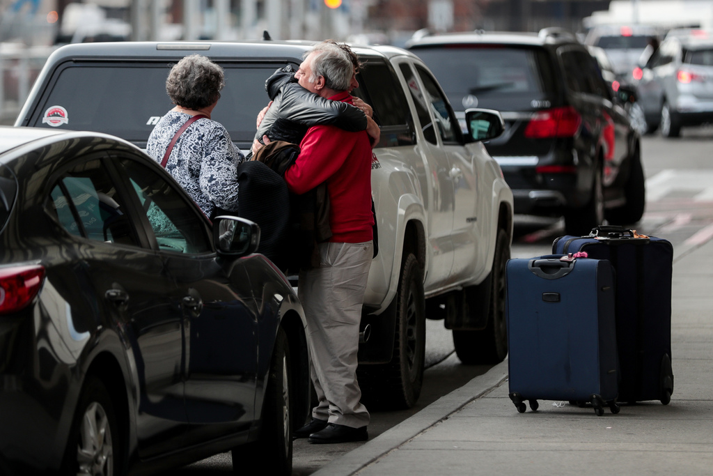 Erma Catino, center, bids farewell to his parents, Maryann and Teddy Catino, who were visiting from their home in Stamford, Conn., at the Salt Lake City International Airport on Tuesday, Nov. 19, 2019. (Photo: Spenser Heaps, KSL)