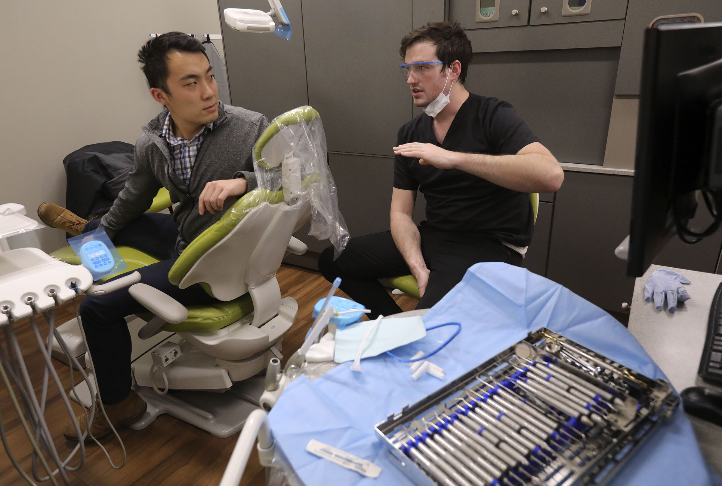 Gilbert Pan talks to dental student Cory McLeod about his teeth at the University of Utah School of Dentistry's new dental clinic at the Liberty Community Learning Center in Salt Lake City on Wednesday, Nov. 20, 2019. (Kristin Murphy, KSL)