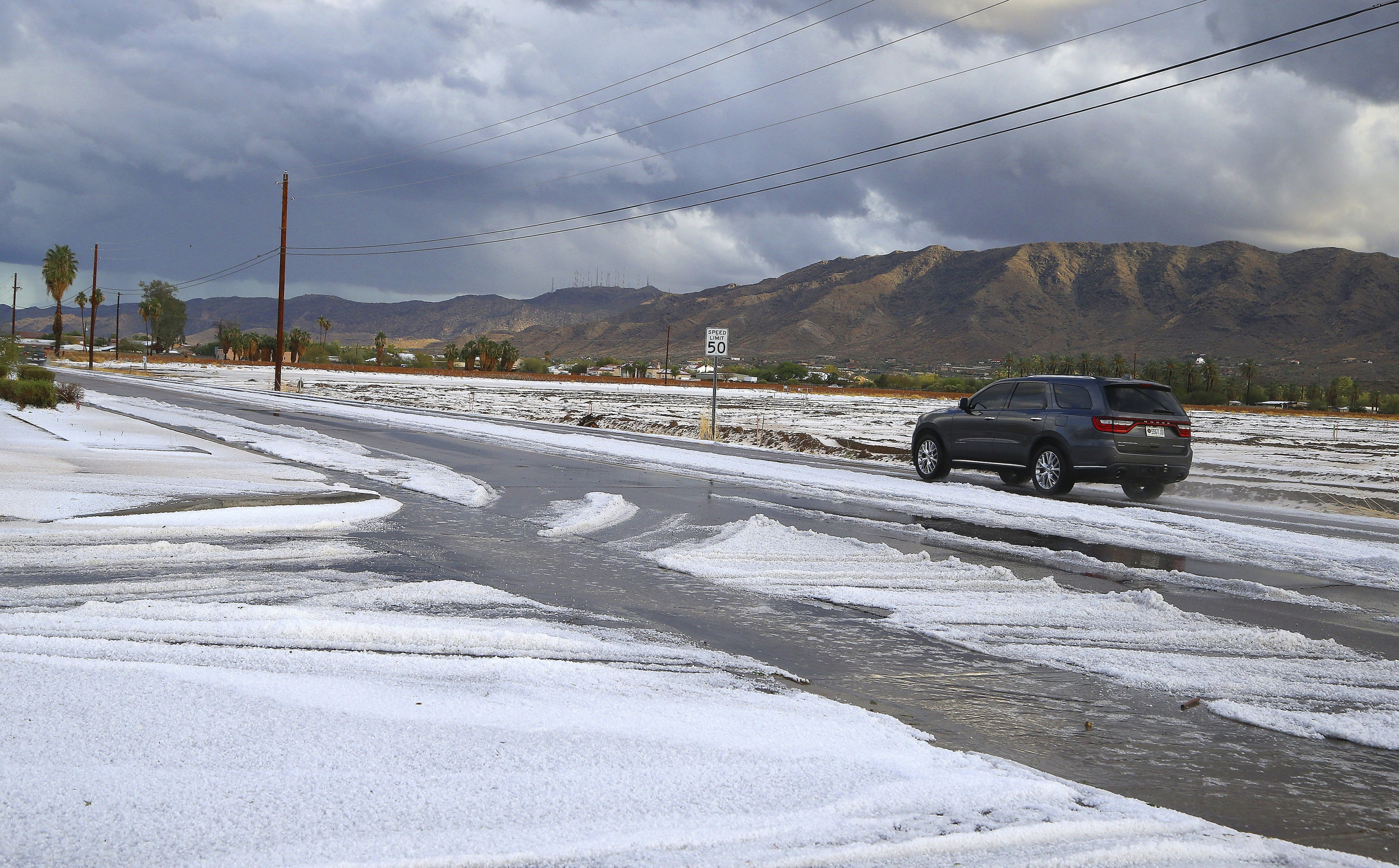 Snow-like hail in Phoenix-area desert caps days of storms