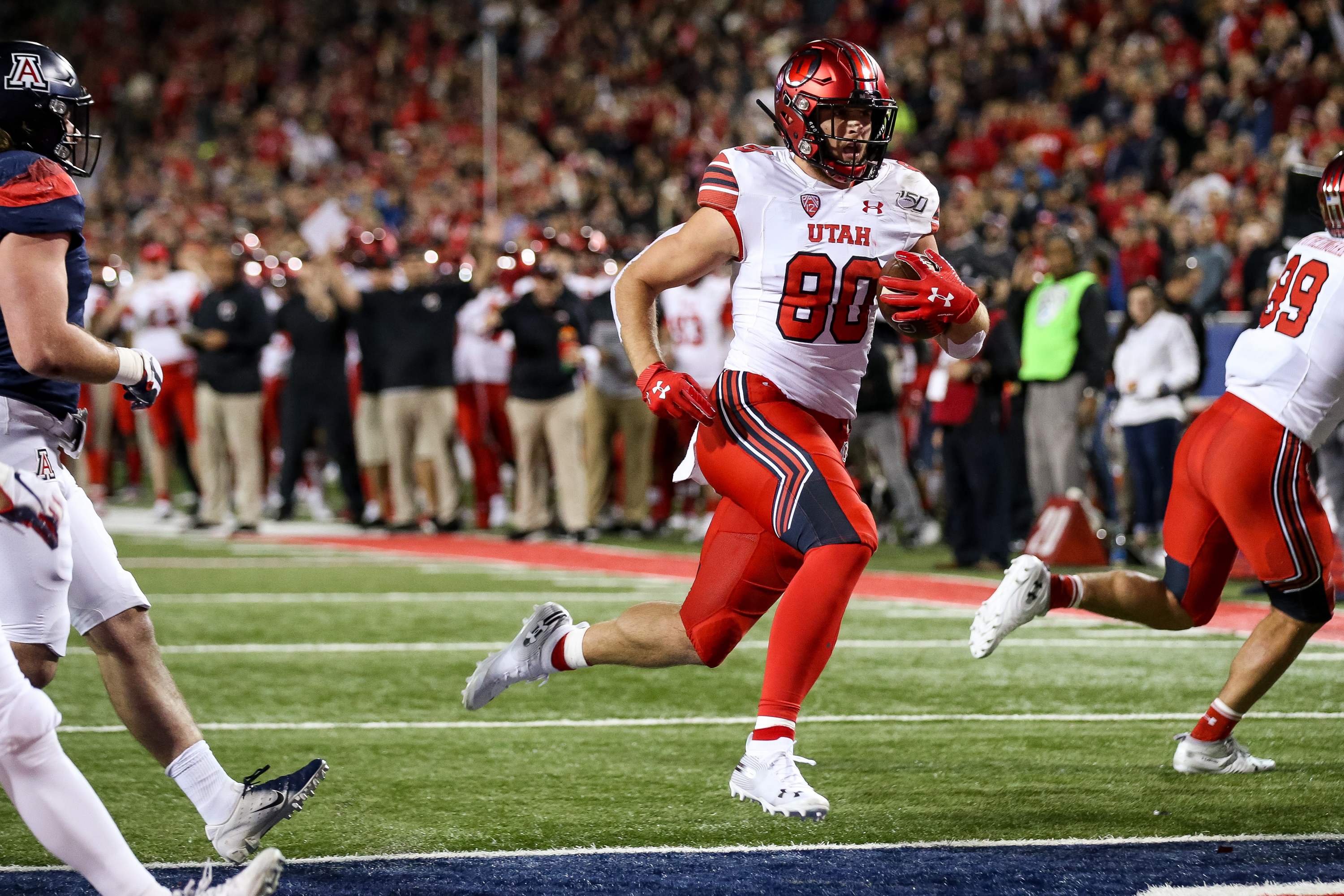 Utah Utes tight end Brant Kuithe (80) runs the ball in for a touchdown, putting the Utes up 7-0 over the Arizona Wildcats after the PAT, at Arizona Stadium in Tucson, Arizona on Saturday, Nov. 23, 2019.