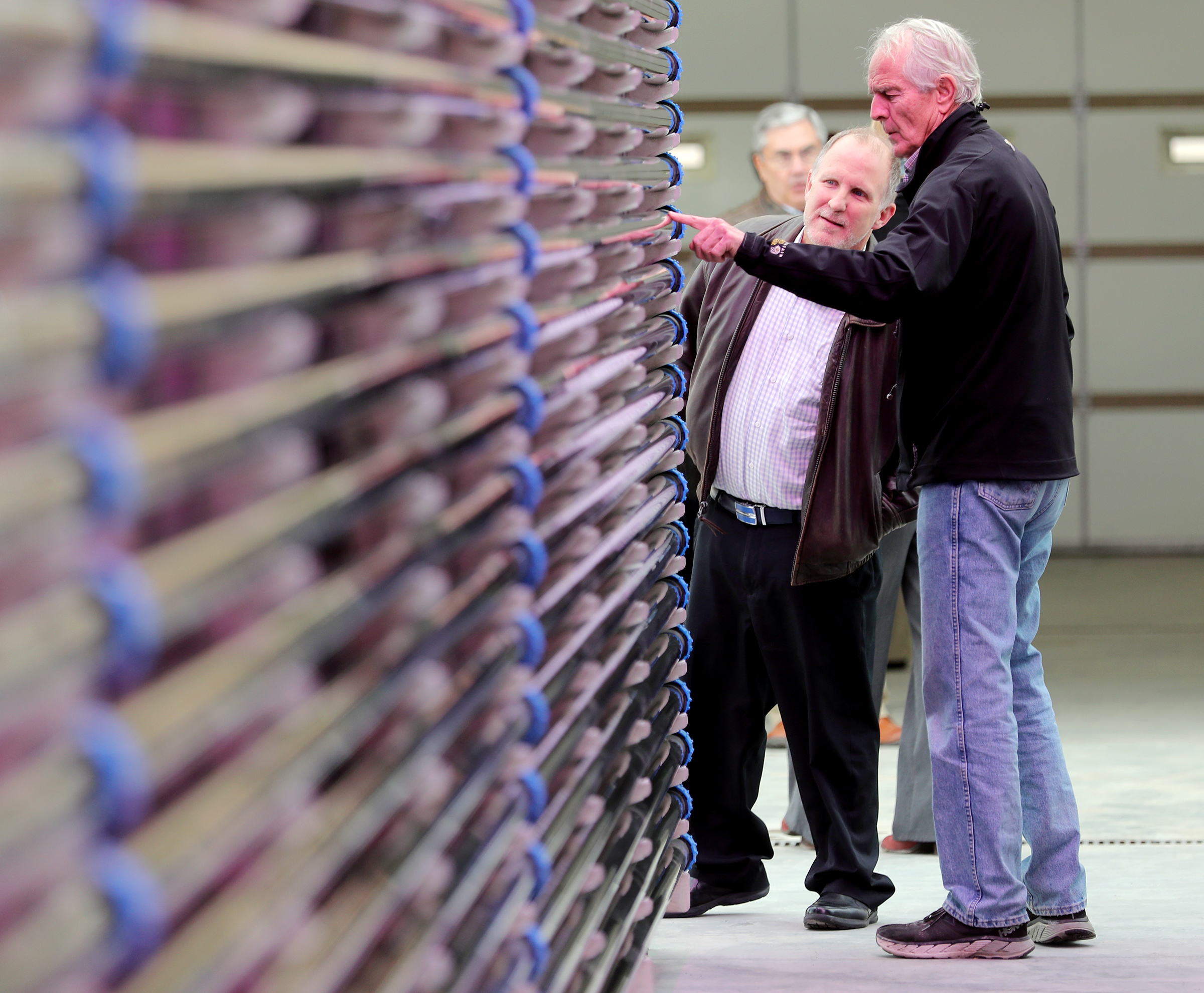 Greg Sopkin, Environmental Protection Agency regional administrator, looks at algae inside a photobioreactor with Bruce Alder, Wasatch Resource Recovery principal, during a tour of the Wasatch Resource Recovery food waste facility in North Salt Lake on Wednesday, Nov. 20, 2019. (Scott G. Winterton, KSL)