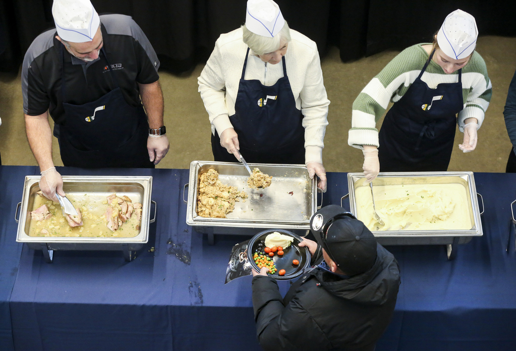 Utah Jazz owner Gail Miller, center, and other volunteers serve food during the 21st annual "We Care - We Share" Thanksgiving meal event for the homeless and low-income individuals at the Vivint Smart Home Arena in Salt Lake City on Monday, Nov. 25, 2019. (Photo: Colter Peterson, KSL)