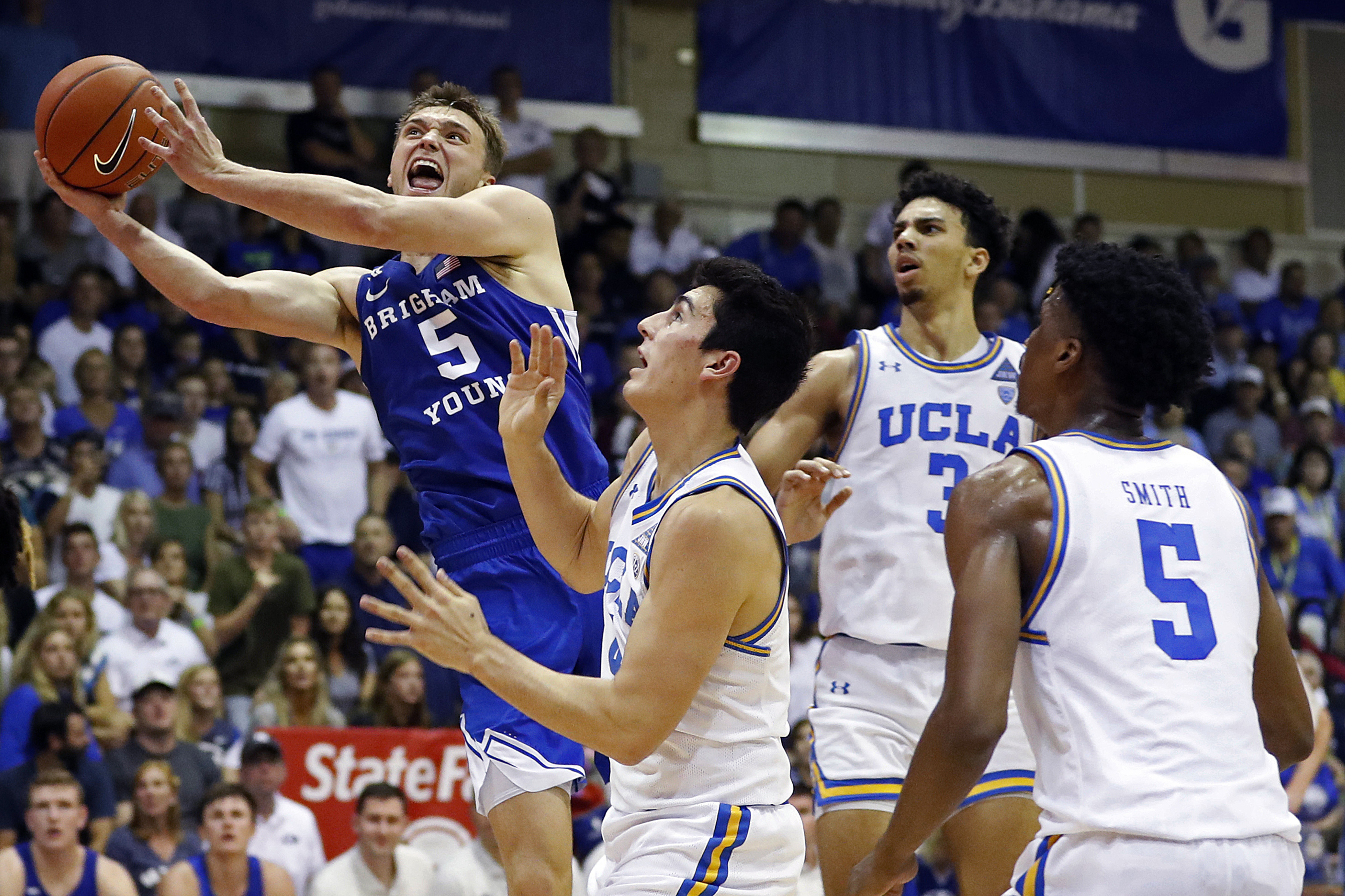 BYU guard Jake Toolson (5) shoots over the UCLA defense during the second half of an NCAA college basketball game, Monday, Nov. 25, 2019, in Lahaina, Hawaii. (AP Photo/Marco Garcia)