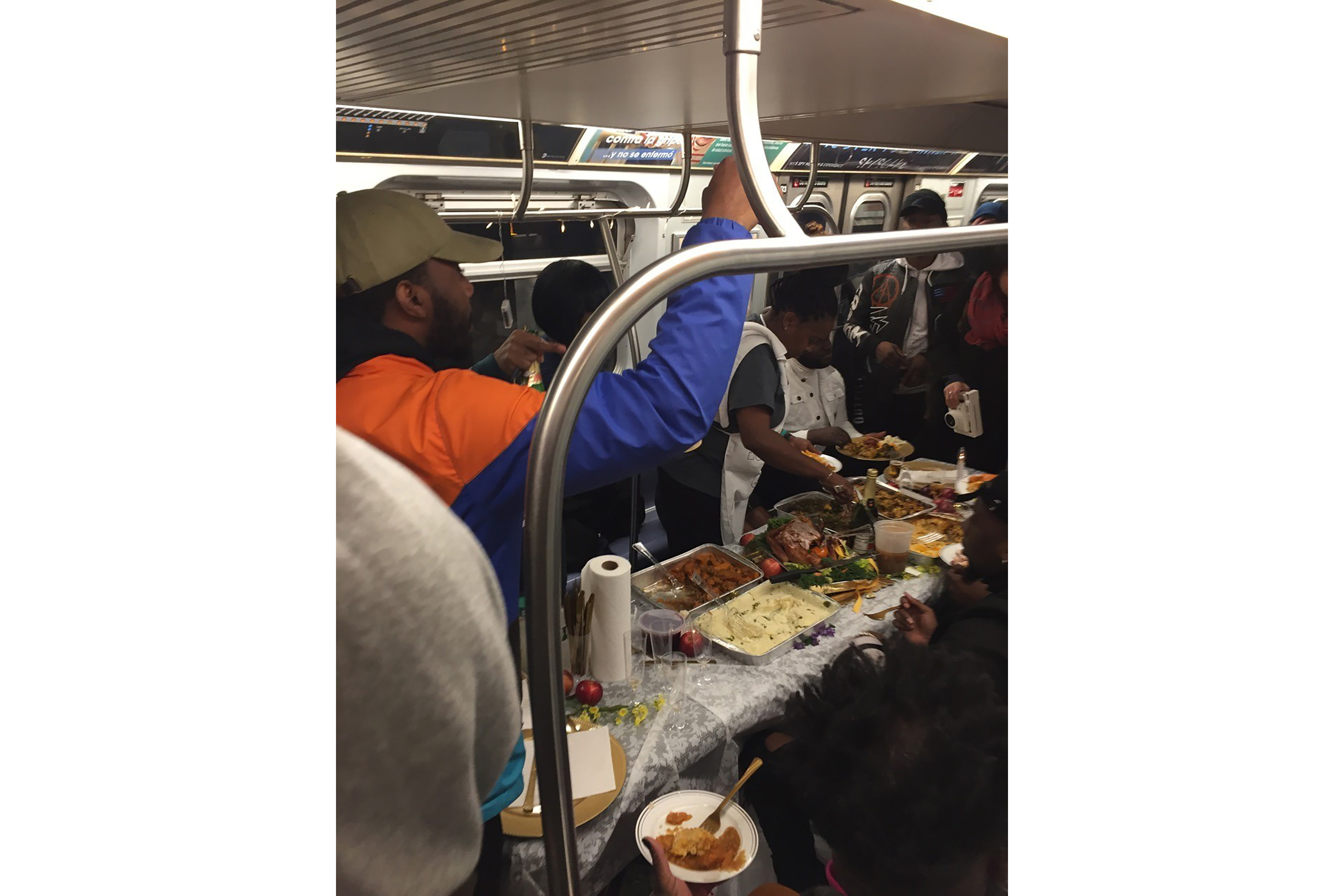 NYC commuters enjoy Thanksgiving feast on subway car