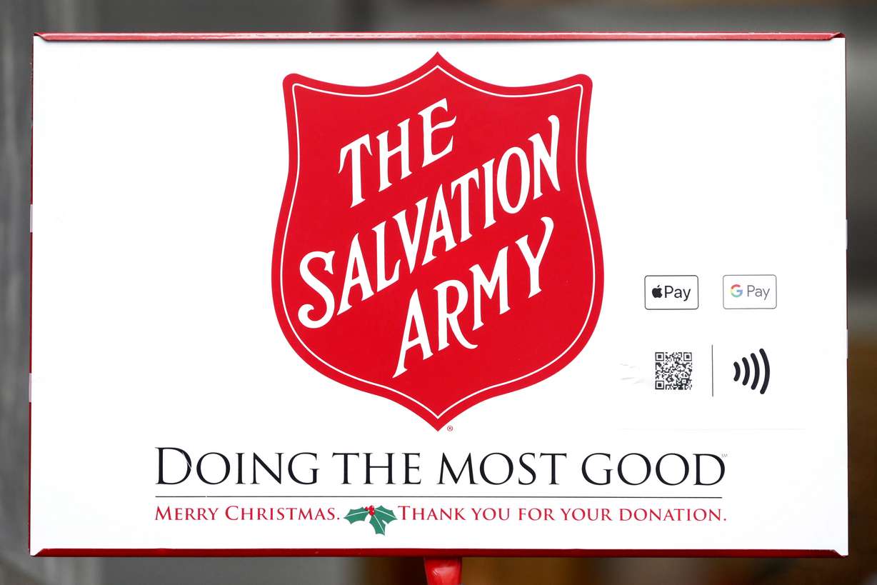 In this Friday, Nov. 15, 2019, photo, two ways to donate via Apple Pay and Google Pay to the Salvation Army's annual holiday red kettle campaign are incorporated next to the Army's iconic red shield on Chicago's Magnificent Mile. Photo: Charles Rex Arbogast, AP Photo