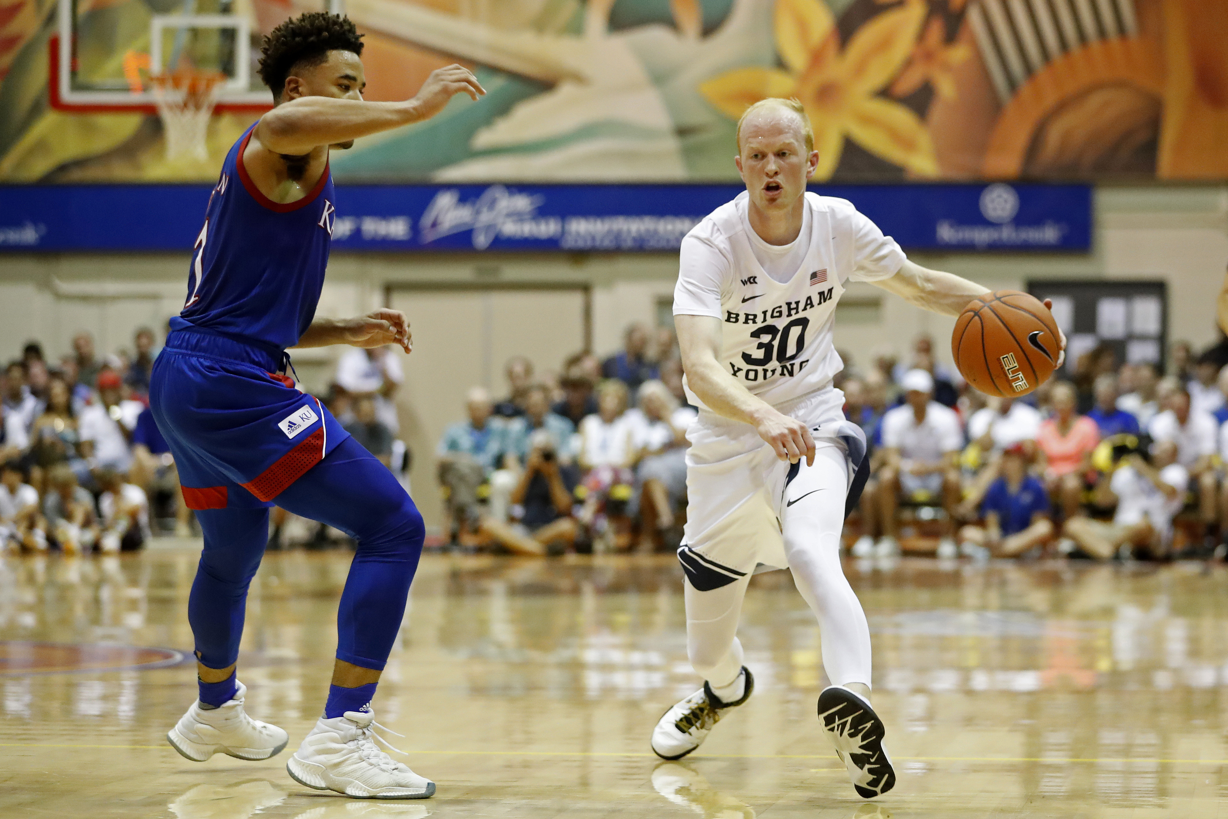 BYU guard TJ Haws (30) tries to get around Kansas guard Devon Dotson (1) during the first half of an NCAA college basketball game, Tuesday, Nov. 26, 2019, in Lahaina, Hawaii. (AP Photo/Marco Garcia)