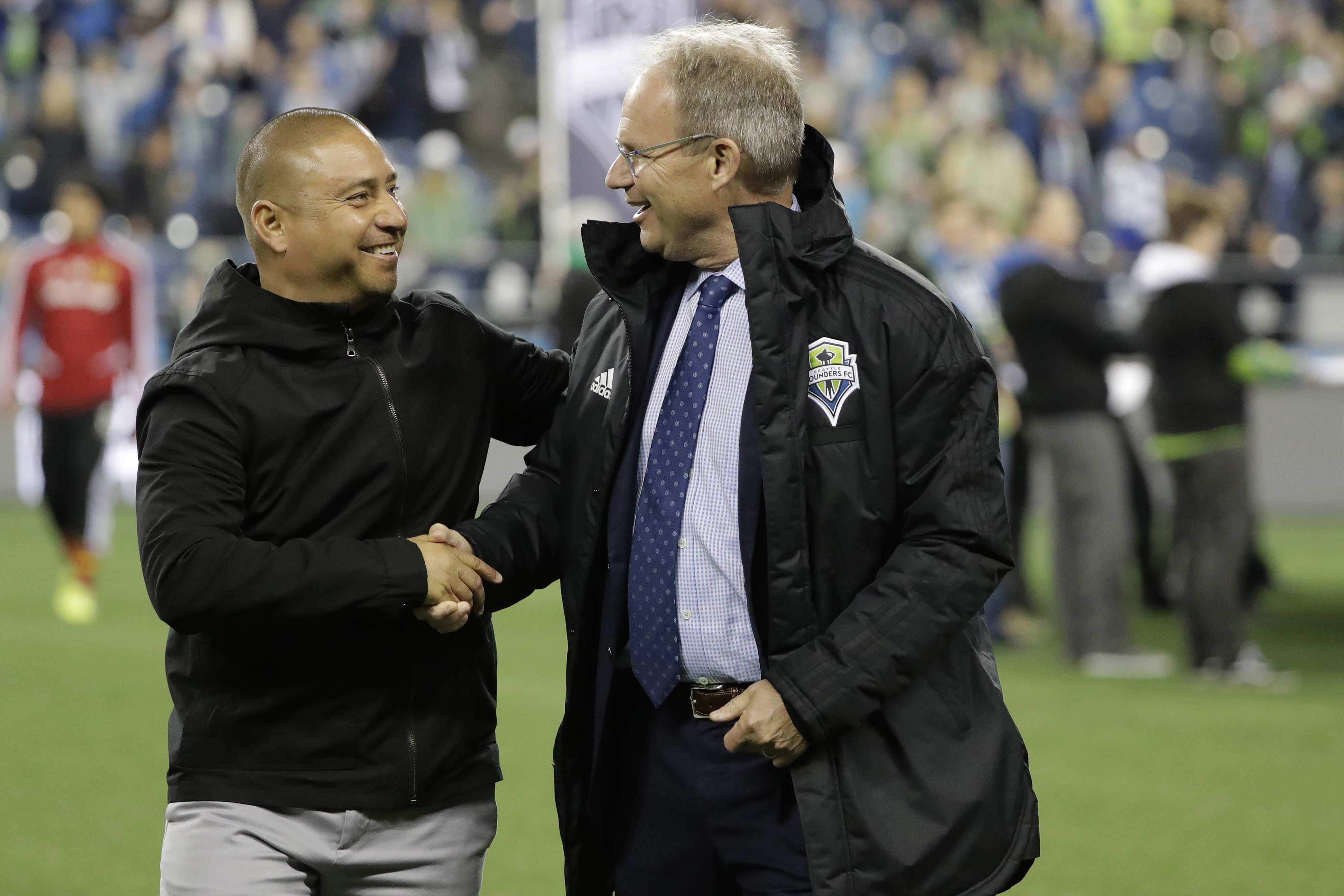Real Salt Lake interim coach Freddy Juarez, left, shakes hands with Seattle Sounders coach Brian Schmetzer before an MLS Western Conference semifinal playoff soccer match Wednesday, Oct. 23, 2019, in Seattle. The Sounders won 2-0. (Photo: Ted S. Warren, AP)