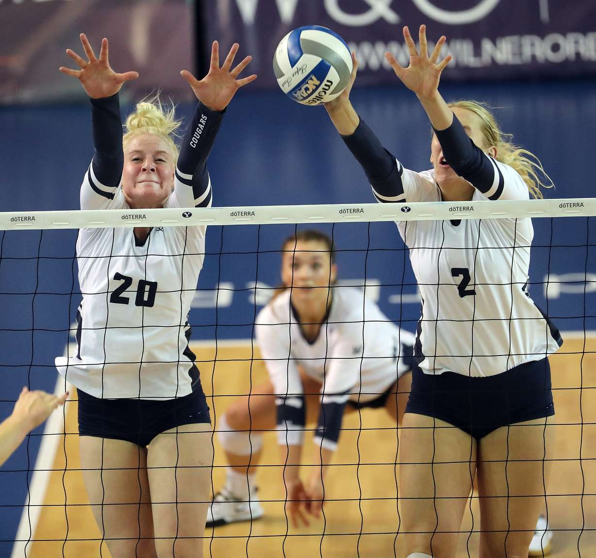 Riley Lyman, left, and Heather Gneiting of BYU go for a block against San Diego during an NCAA volleyball match in Provo on Friday, Oct. 18, 2019. (Photo: Ravell Call, KSL)