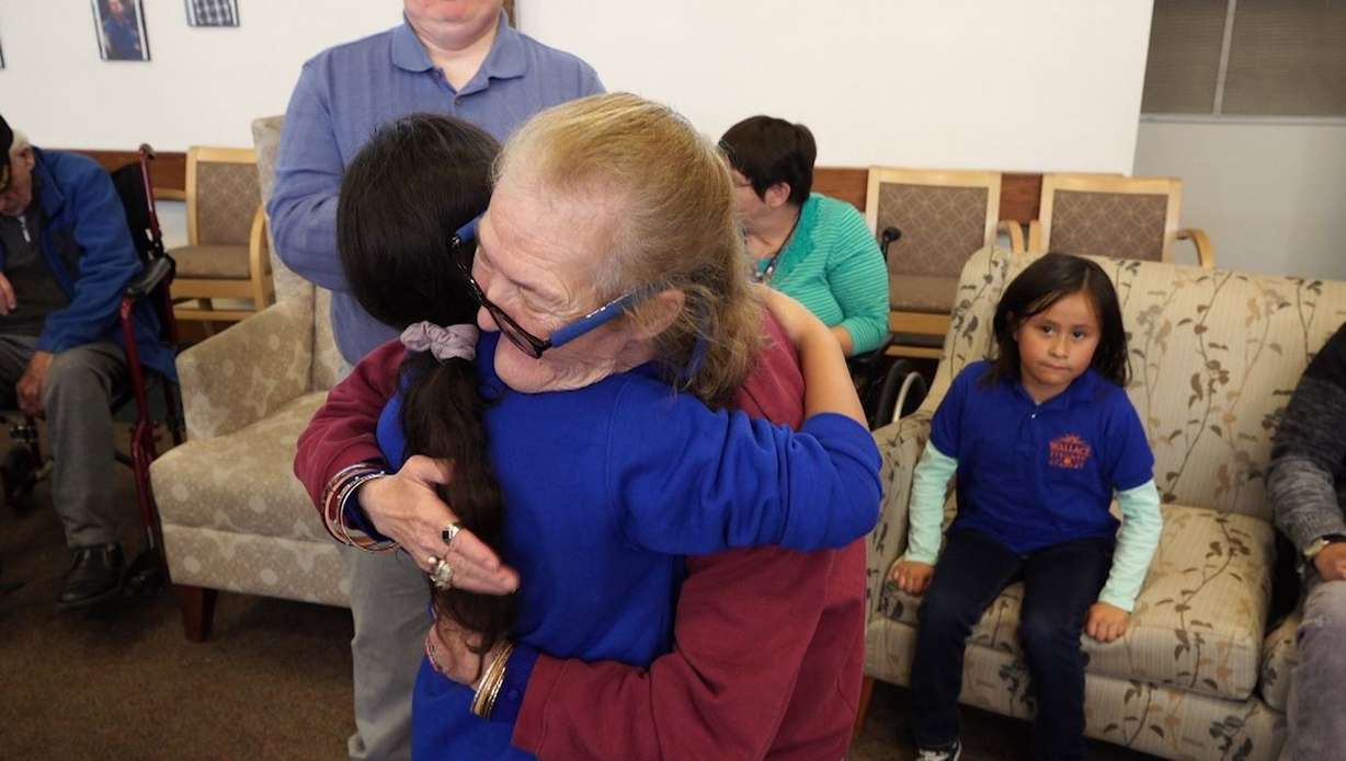 Linda Curtis, 71, hugs Alesha Aumua, 9. (Photo: Aley Davis)