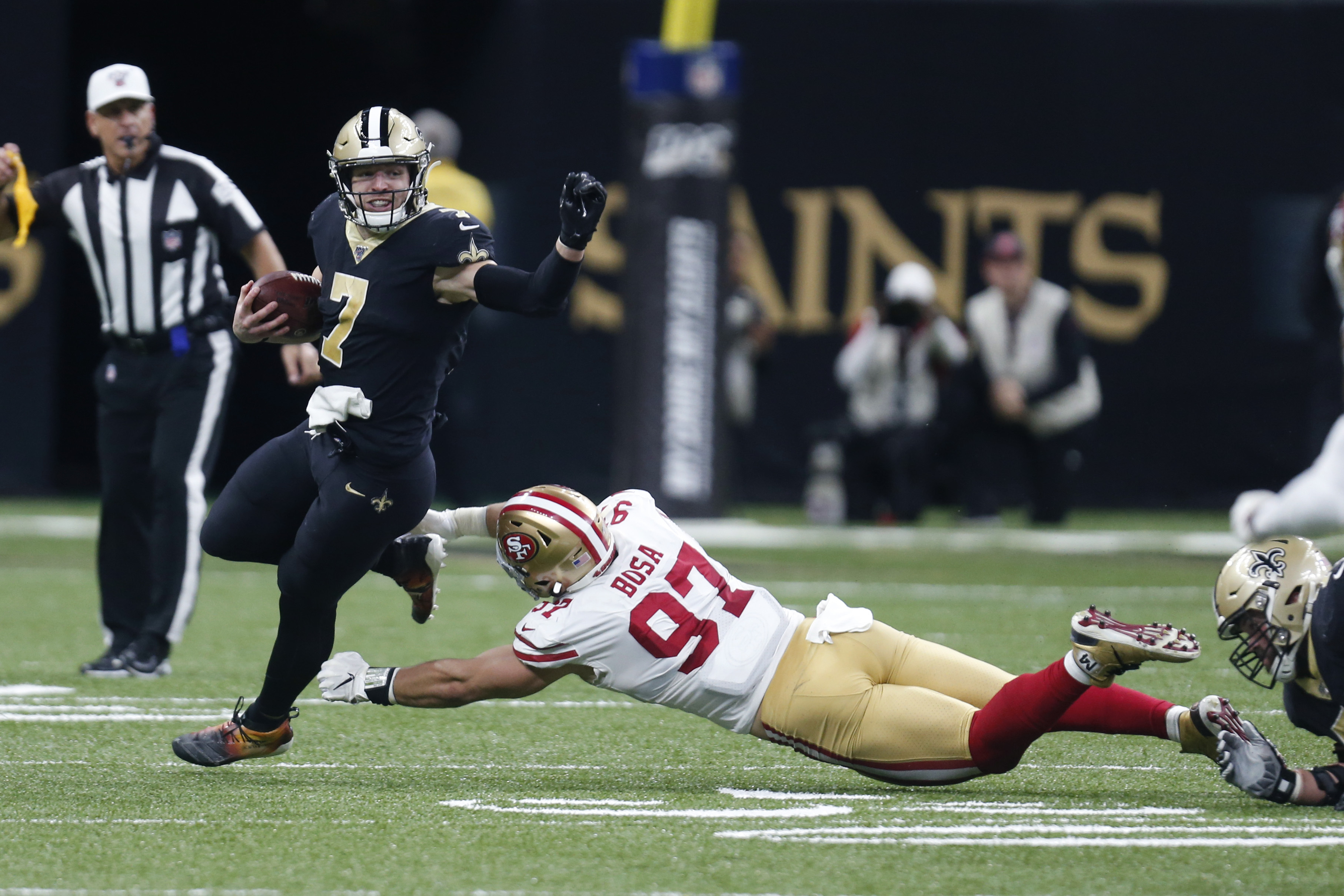 San Francisco 49ers defensive end Nick Bosa (97) tries to tackle New Orleans Saints quarterback Taysom Hill (7) in the first half an NFL football game in New Orleans, Sunday, Dec. 8, 2019. (Photo: Butch Dill, AP)