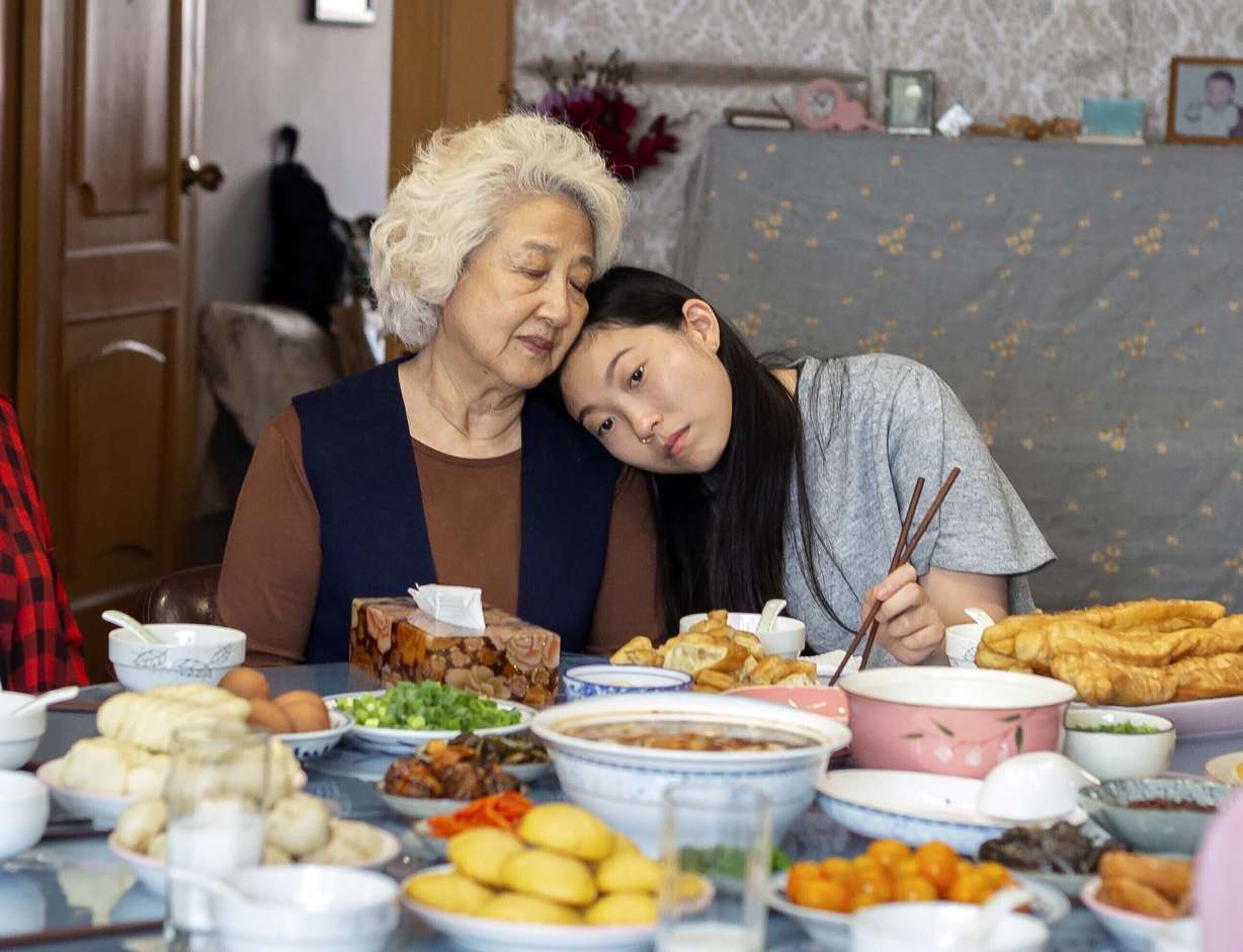 This image released by A24 films shows Zhao Shuzhen, left, and Awkwafina in a scene from "The Farewell." On Monday, Dec. 9, 2019, Awkwafina was nominated for a Golden Globe for best actress in a motion picture comedy for her role in the film. (Casi Moss, A24 via AP)