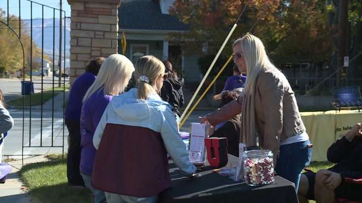Stephanie Keller hands out health care information as part of her job with the University of Utah Health Plans. Photo: KSL TV