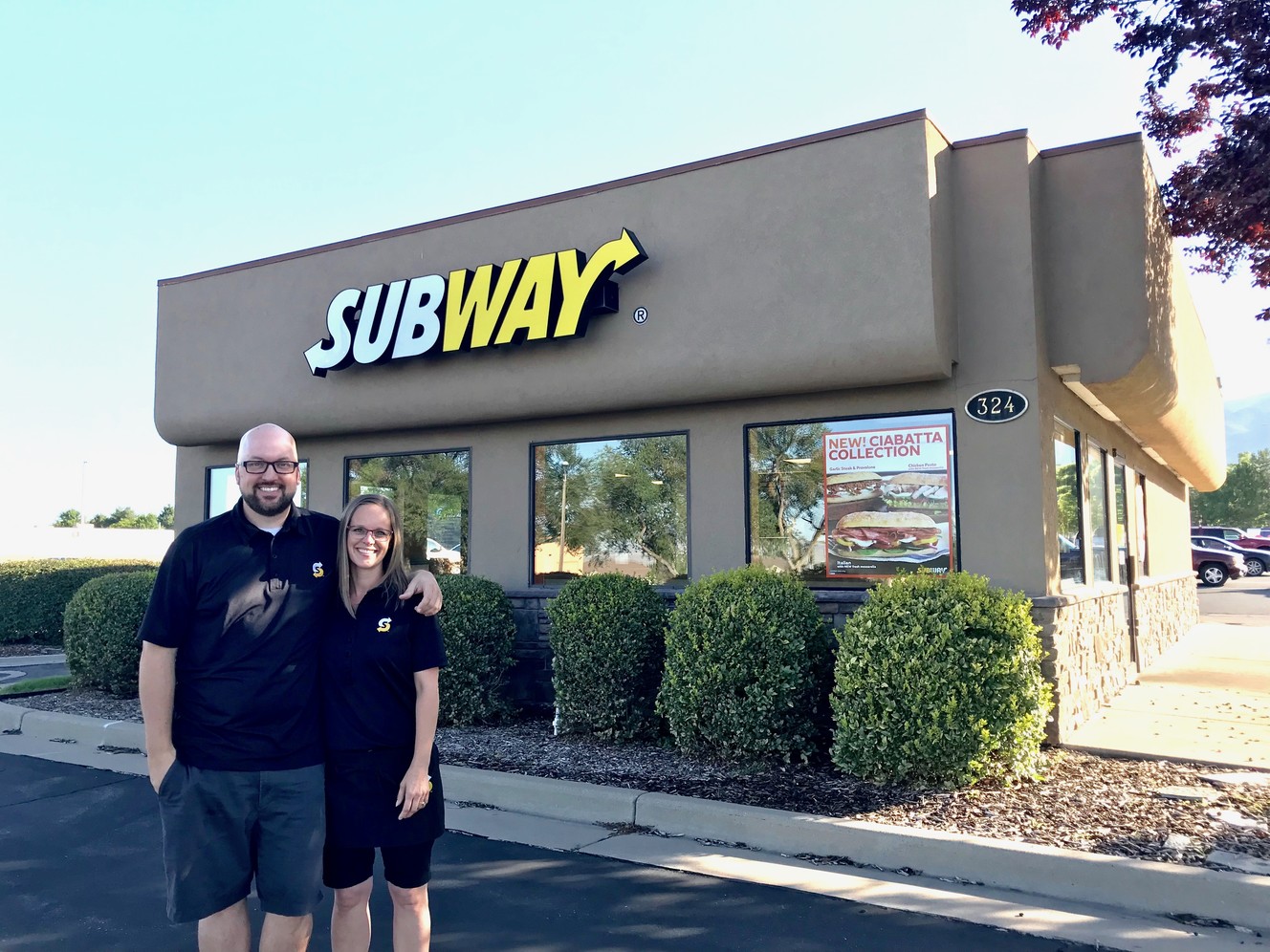 Jordan and Jennifer Olsen stand outside the Kaysville Subway shop at 324 N. Main Street, where they both worked and fell in love over 20 years ago. They donated all profits from "Senior Day" last week to their graduating employees.