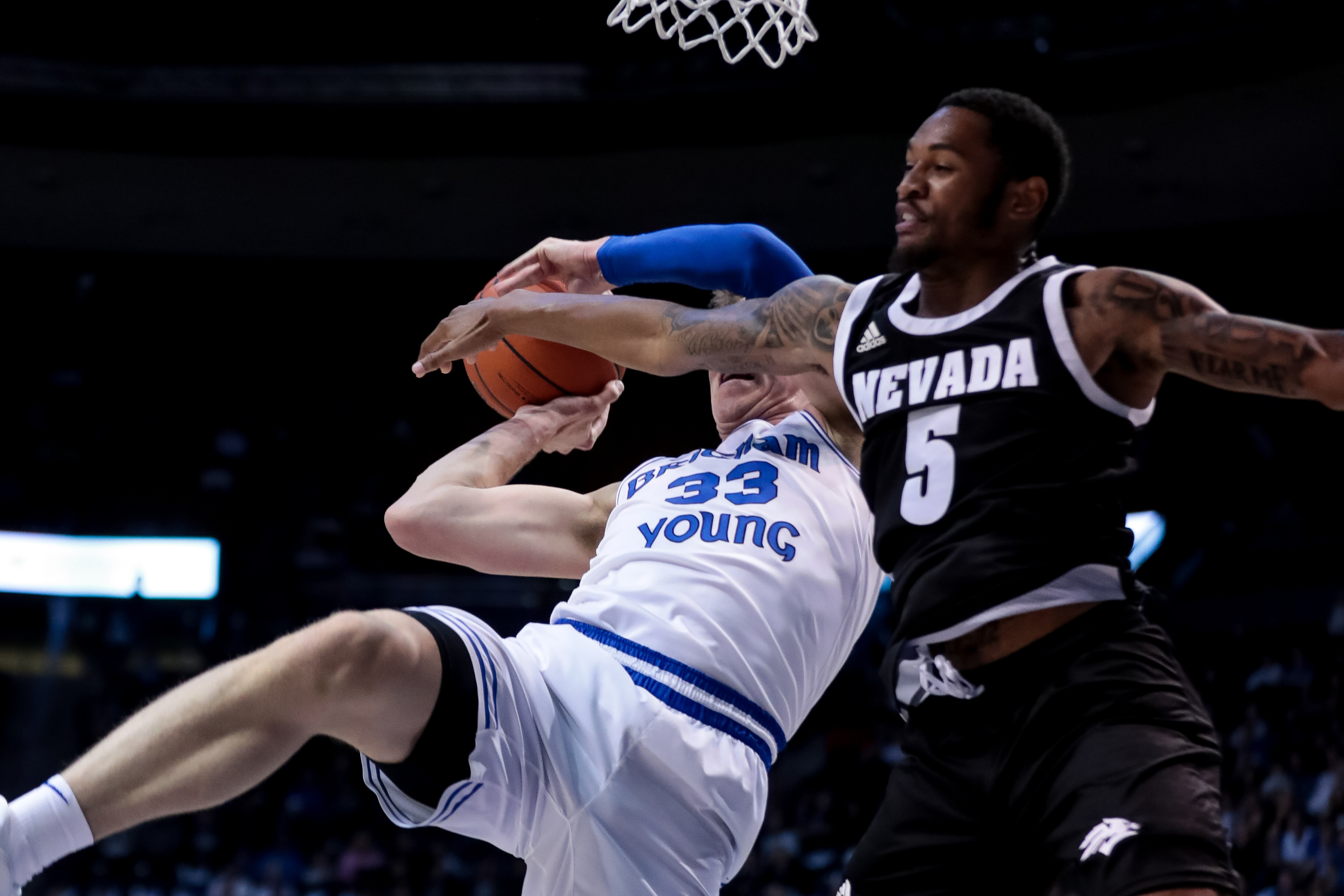 Nevada Wolf Pack guard Nisre Zouzoua (5) fouls Brigham Young Cougars forward Dalton Nixon (33) during the game at the Marriott Center in Provo on Tuesday, Dec. 10, 2019. (Photo: Spenser Heaps, KSL)