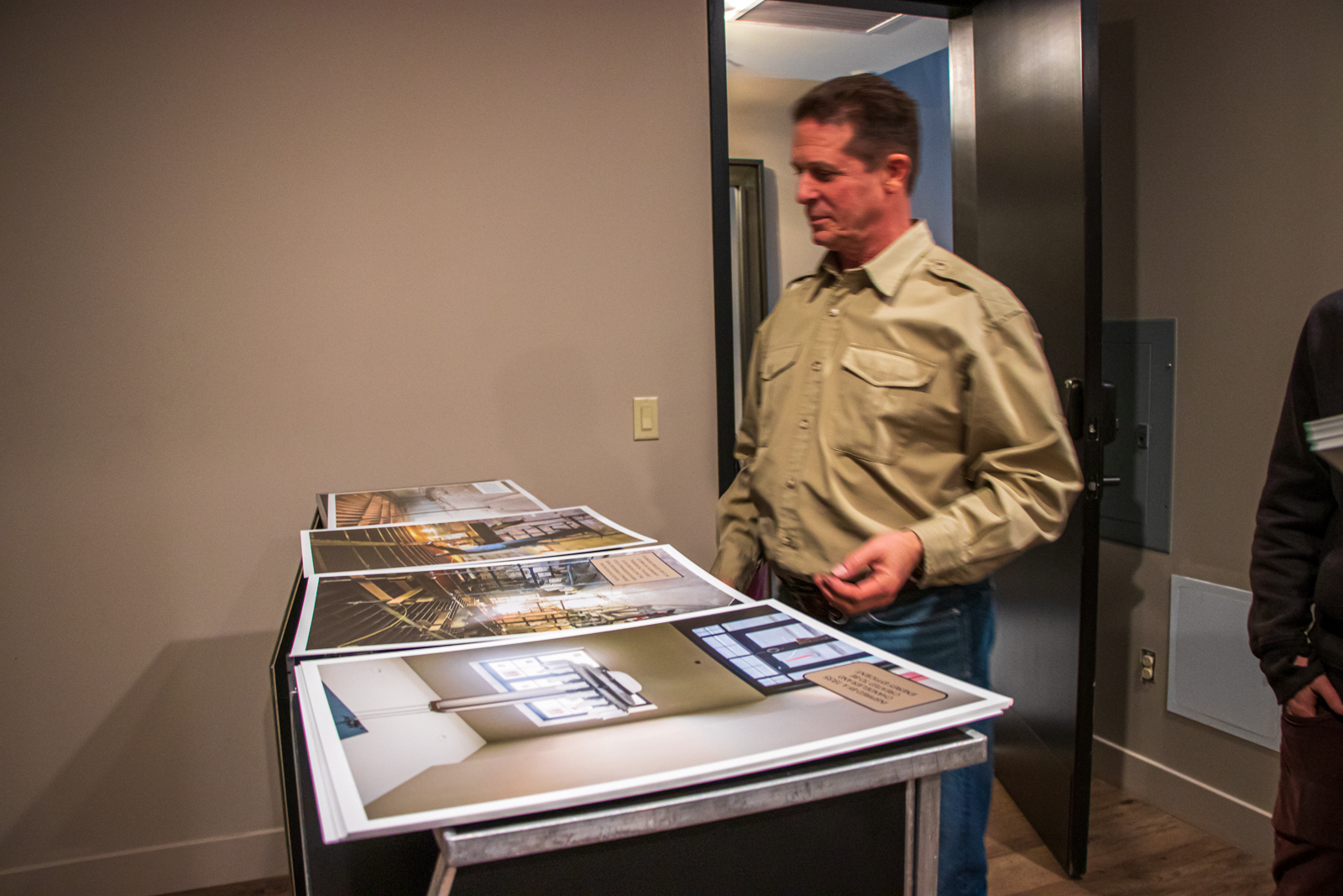 James Hardy, project manager of J.L. Hardy Construction, looks at photos that were taken throughout the renovation process during a tour of Salt Lake Costume Apartments on Thursday, Dec. 12, 2019. The photos will be on display during an open house Friday, Dec. 13, 2019. (Photo: Carter Williams, KSL.com)