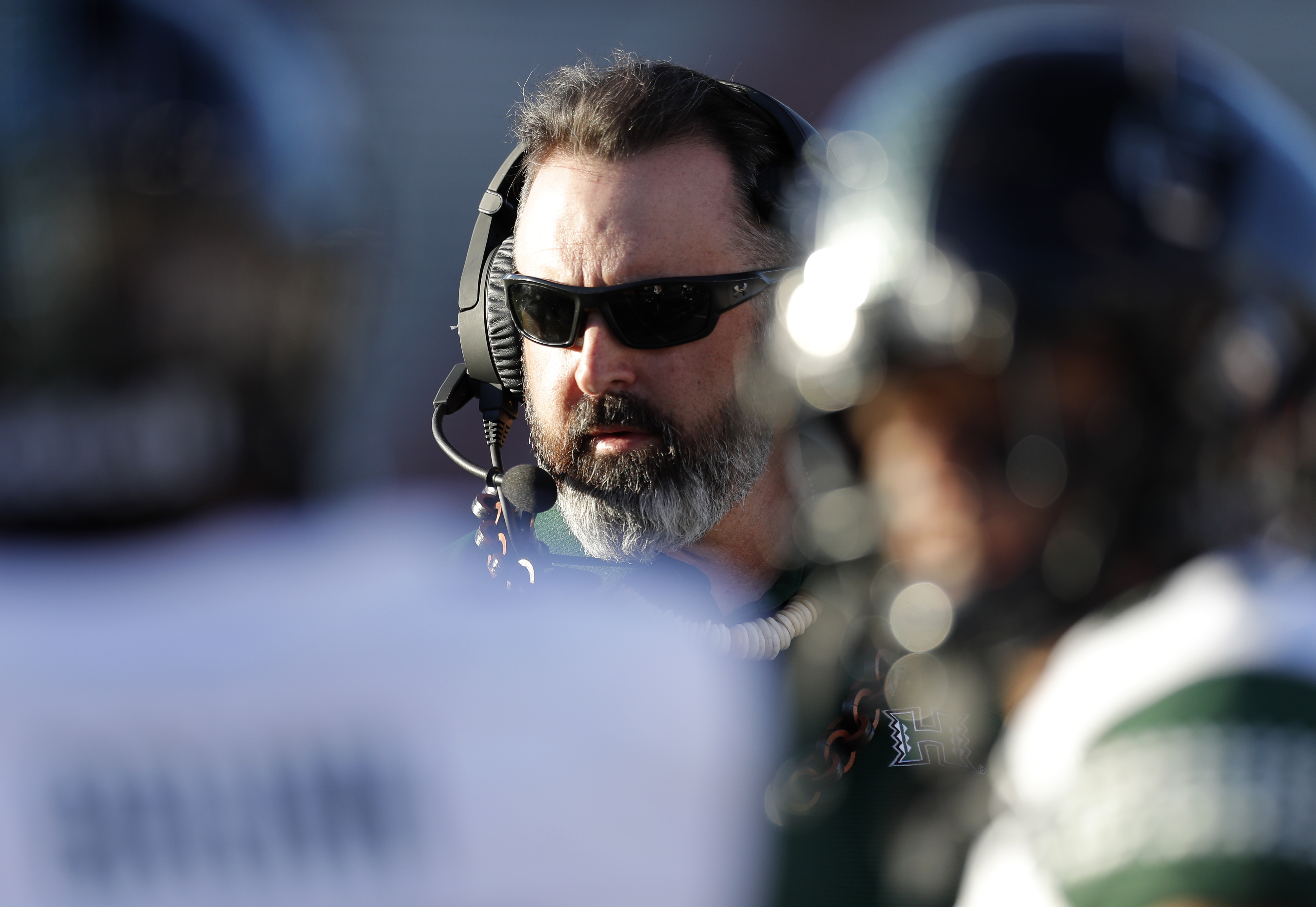 Hawaii coach Nick Rolovich speaks to his players during a timeout in the second half of an NCAA college football game against New Mexico, Saturday, Oct. 26, 2019, in Albuquerque, N.M. (AP Photo/Andres Leighton)