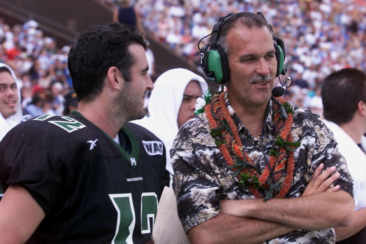 Hawaii coach June Jones and quarterback Nick Rolovich exchange laughs during the fourth quarter action against BYU at Aloha Stadium in Honolulu Saturday, Dec. 8, 2001. (AP Photo/Ronen Zilberman)