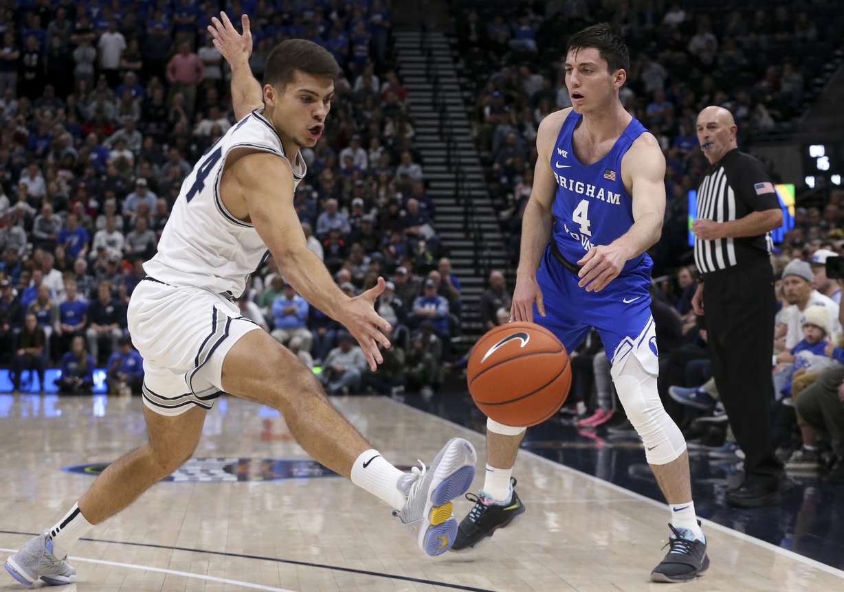 Utah State Aggies guard Diogo Brito (24) kicks a pass from Brigham Young Cougars guard Alex Barcello (4) out of bounds during the first half of an NCAA basketball game in the Beehive Classic at Vivint Arena in Salt Lake City on Saturday, Dec. 14, 2019. (Photo: Colter Peterson, KSL)