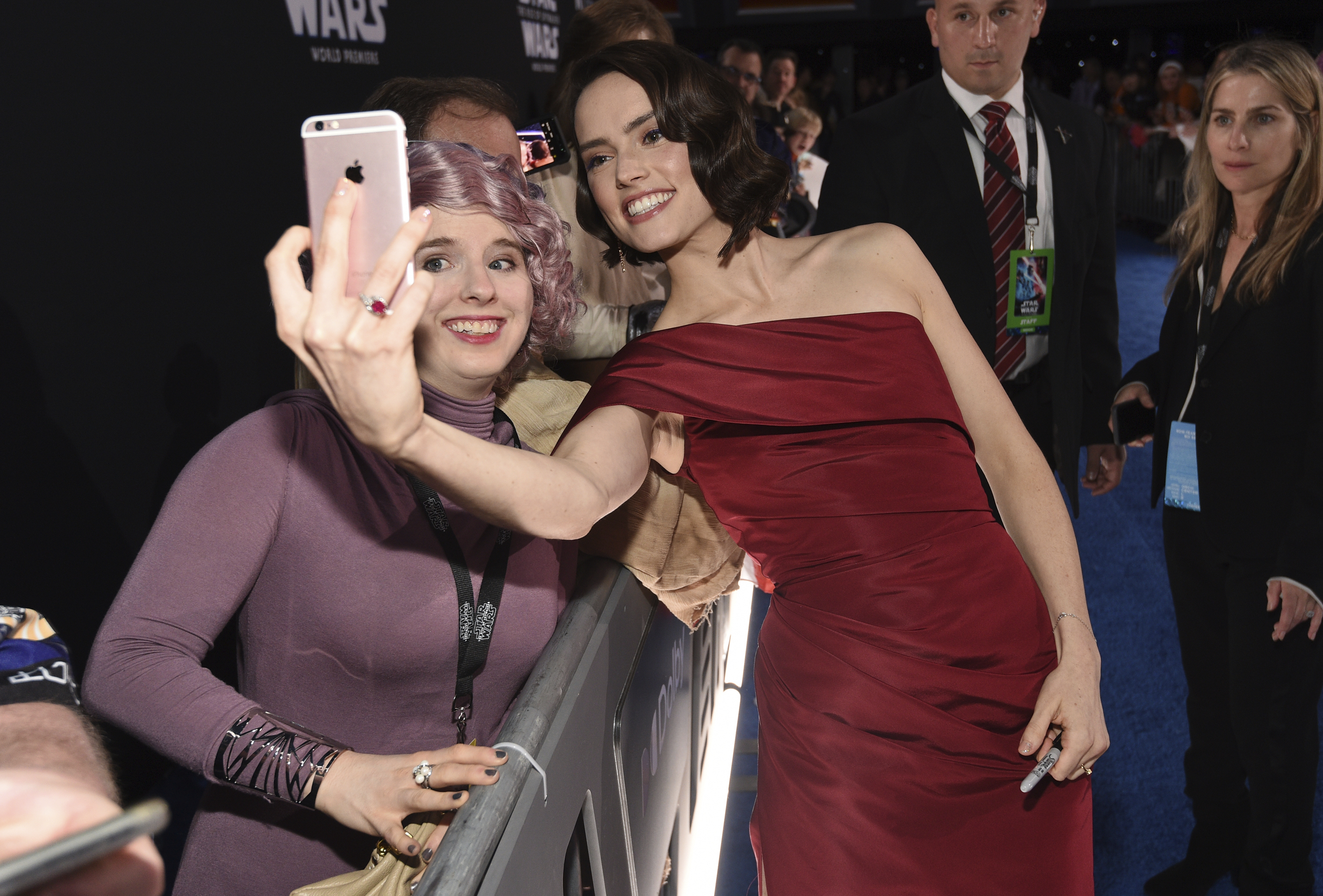 Daisy Ridley, right, takes a selfie with a fan as she arrives at the world premiere of 'Star Wars: The Rise of Skywalker' on Monday, Dec. 16, 2019, in Los Angeles (AP Photo/Chris Pizzello)