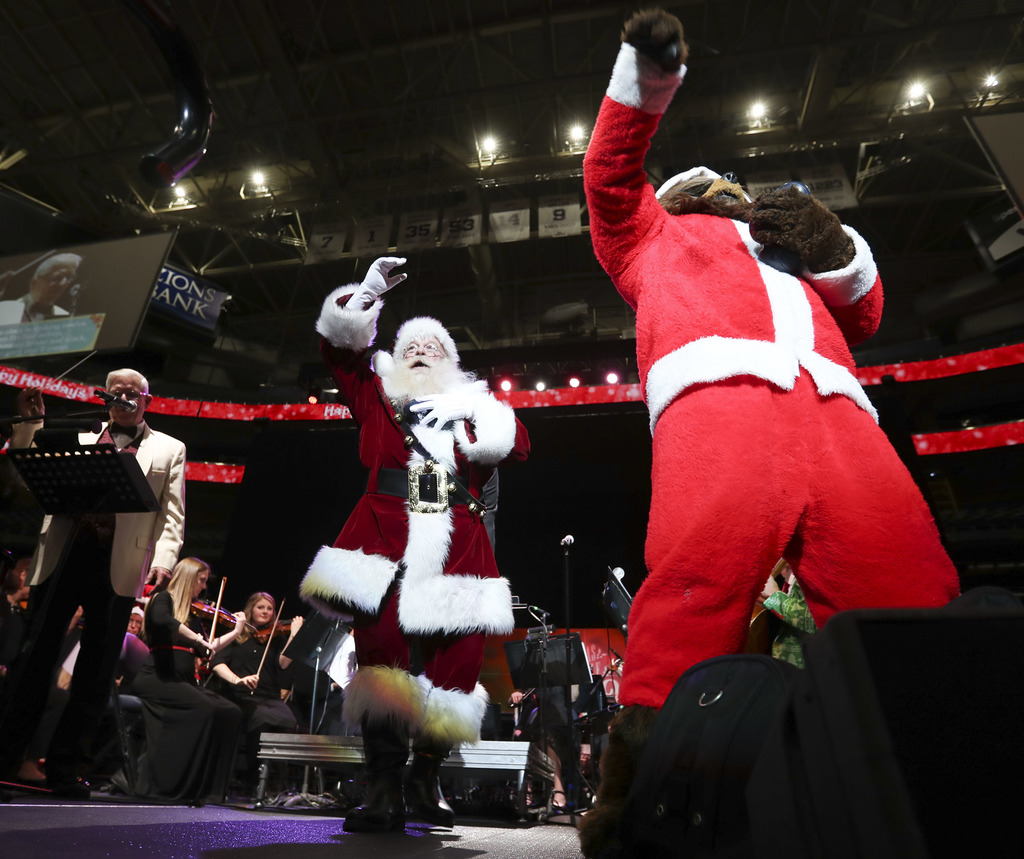 Santa and the Utah Jazz Bear throw toys to children during the Larry H. Miller family’s 35th annual Christmas carol singalong at Vivint Arena in Salt Lake City on Monday, Dec. 16, 2019. (Photo: Steve Griffin, KSL)