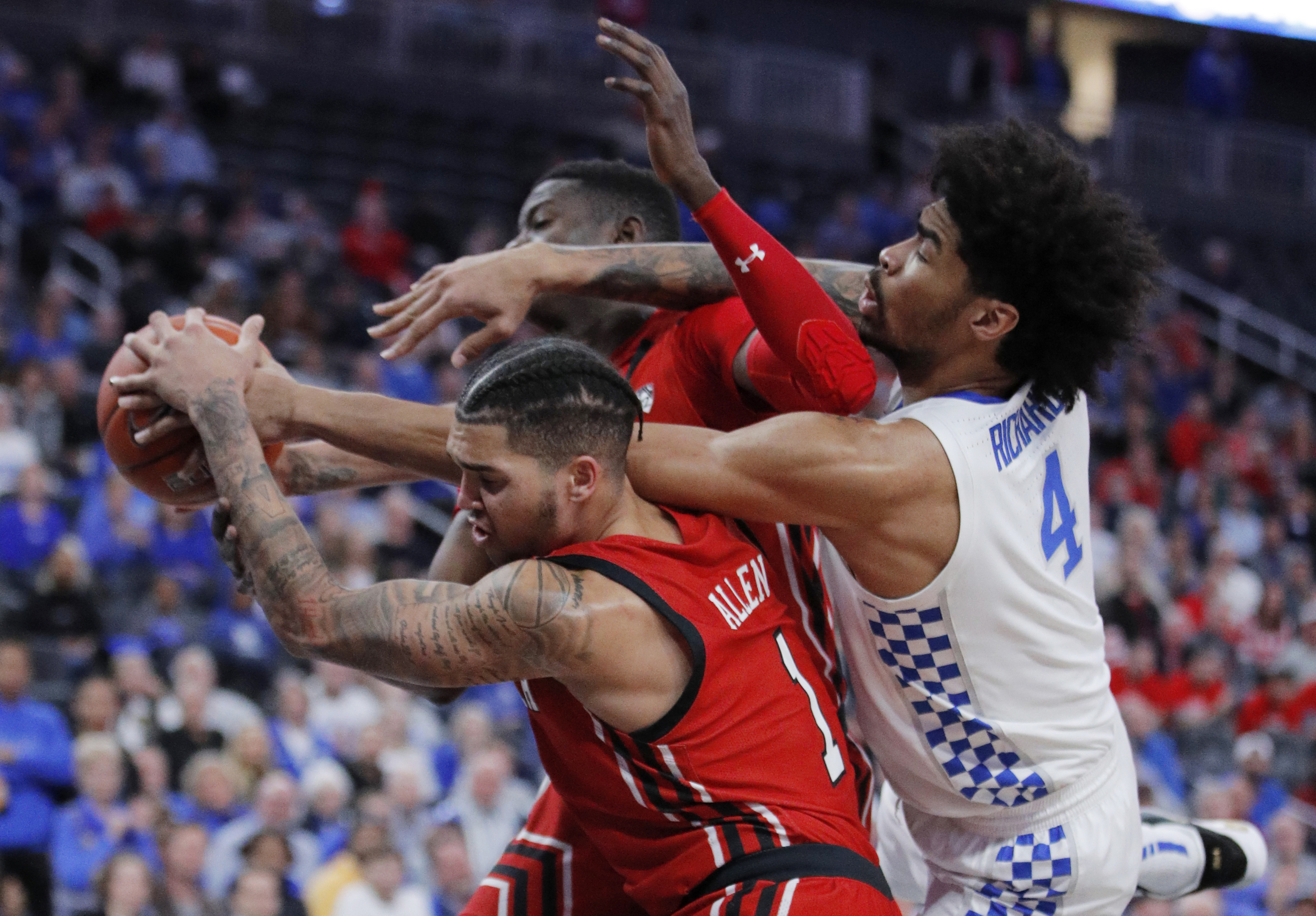 Kentucky's Nick Richards (4) fouls Utah's Timmy Allen (1) during the second half of an NCAA college basketball game Wednesday, Dec. 18, 2019, in Las Vegas. (Photo: John Locher, AP Photo)
