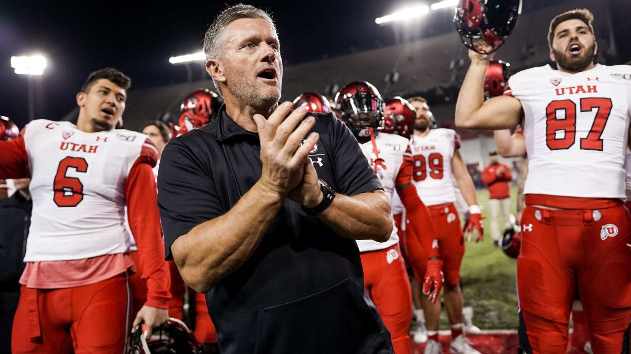 Utah Utes head coach Kyle Whittingham and players celebrate their 35-7 win over the Arizona Wildcats at Arizona Stadium in Tucson, Arizona on Saturday, Nov. 23, 2019.