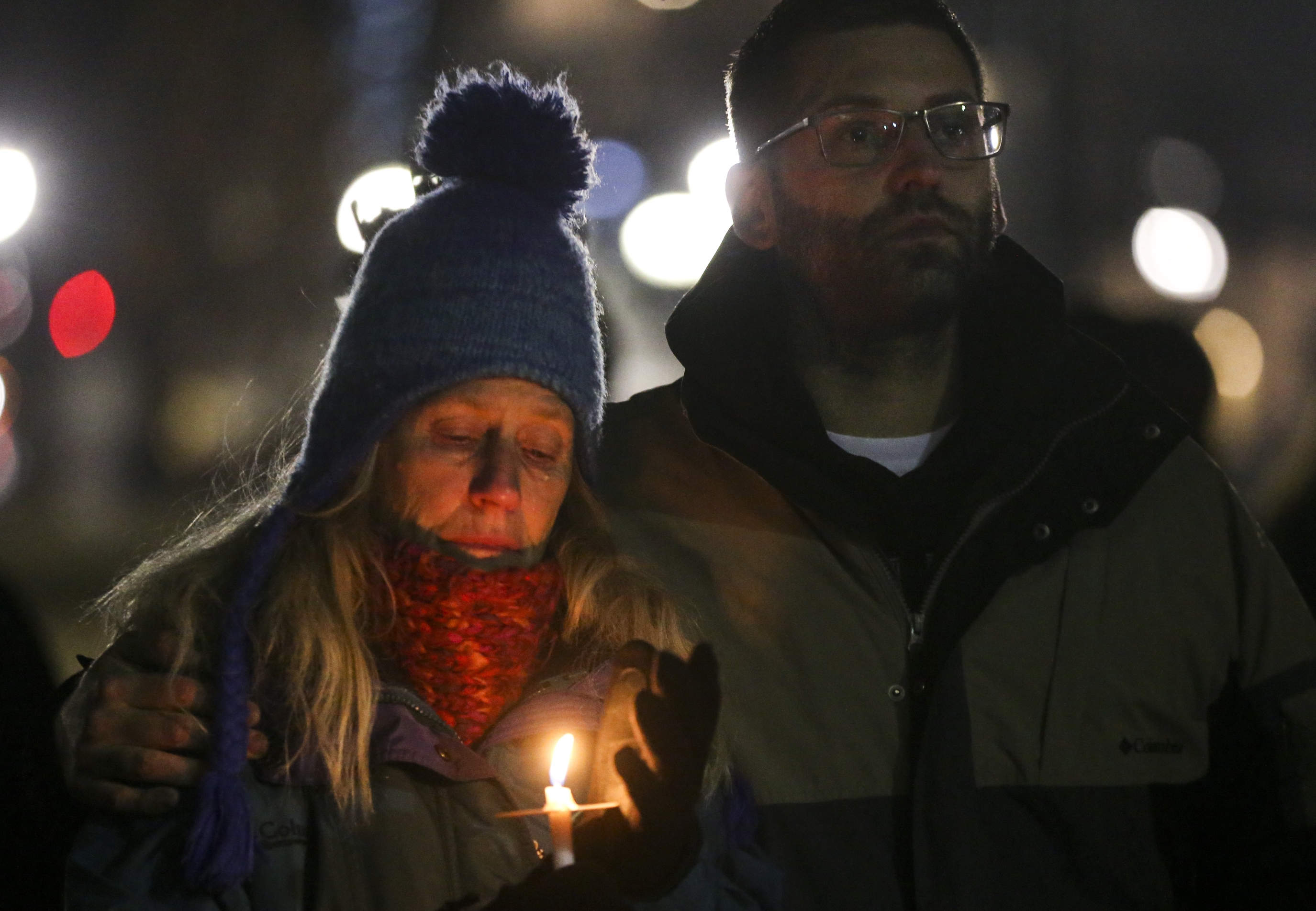 A tear slides down the cheek of Meg Kisselburg, left, while her son Tyson Kisselburg embraces her during the Homeless Persons' Memorial Day candlelight Vigil at Pioneer Park in Salt Lake City on Thursday, Dec. 19, 2019. The vigil is held annually to honor the lives of the homeless men and women who were lost in Salt Lake City throughout the year. In 2019, there were 92 lives lost within the homeless community. (Colter Peterson, KSL)