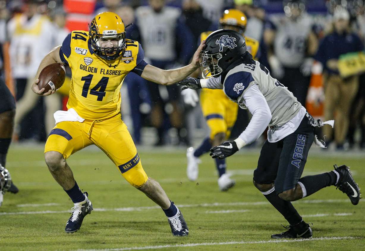 Kent State quarterback Dustin Crum (14) carries the ball as Utah State safety Troy Lefeged Jr. (3) defends during the first half of the Frisco Bowl NCAA college football game Friday, Dec. 20, 2019, in Frisco, Texas. (Photo: Brandon Wade, AP)