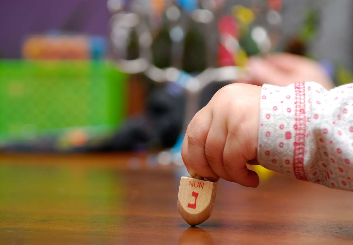 A child spins a dreidel during Hanukkah, which begins Sunday, Dec. 22, 2019. (Photo: Shutterstock)
