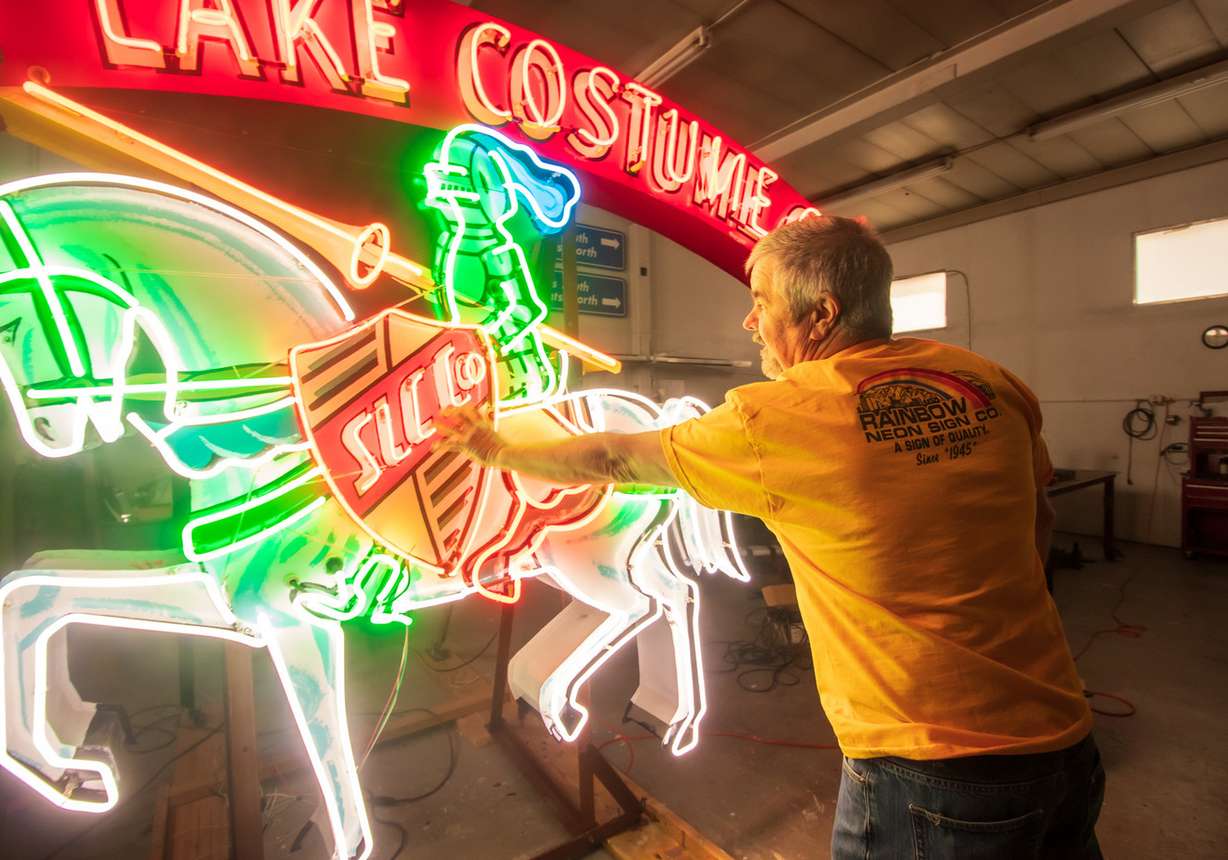 Vince Coley, the owner of Rainbow Neon Sign Company, points out some of the features of the vintage Salt Lake Costume sign while he is in his South Salt Lake shop on Saturday, Dec. 21, 2019. His father, Lloyd, help build the sign in the 1950s. (Photo: Carter Williams, KSL.com)