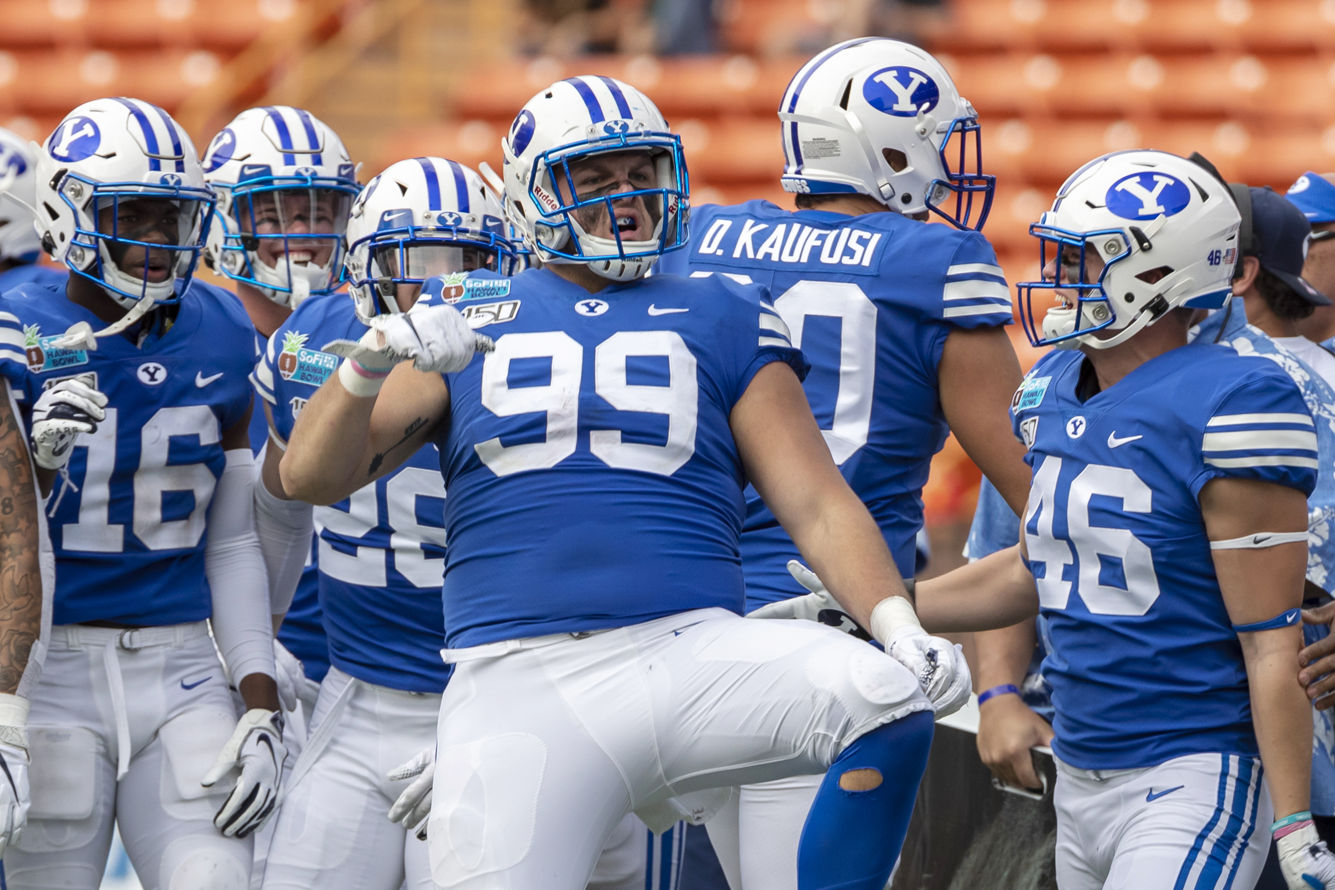 BYU defensive lineman Zac Dawe (99) celebrates recovering a Hawaii fumble and one of eight tackles for loss during the first half of the Hawaii Bowl NCAA college football game Tuesday, Dec. 24, 2019, in Honolulu. (Photo: Eugene Tanner, AP)